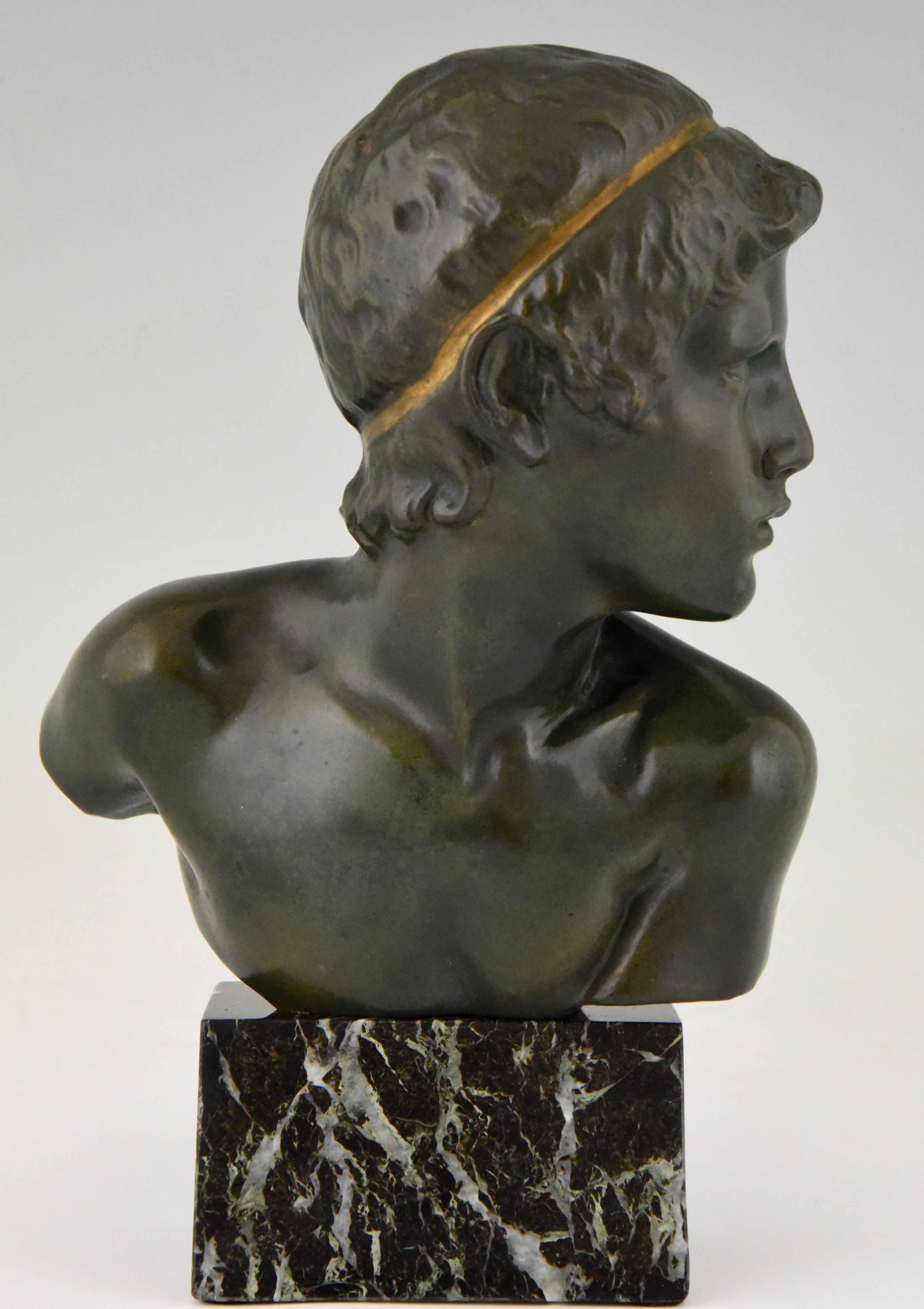 Lovely Art Deco bronze bust of a young boy, picturing Achilles as a child by the French sculptor Constant Roux. The bronze has a dark green patina with gilt accent. The sculpture is mounted on a green marble base, France, 1920. Signed and Foundry