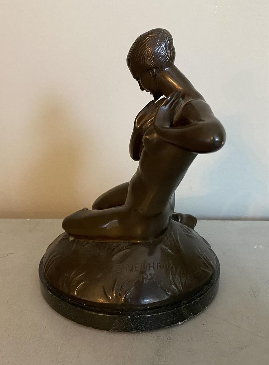 A wonderful Art Deco Bronze Sculpture of a nude by Carl Neuhaus “Die Unerraschung - The Suprise”, Germany dated 1921. The young woman with a frog at her knees, lovely patinated bronze on a black granite base. In excellent original condition for the