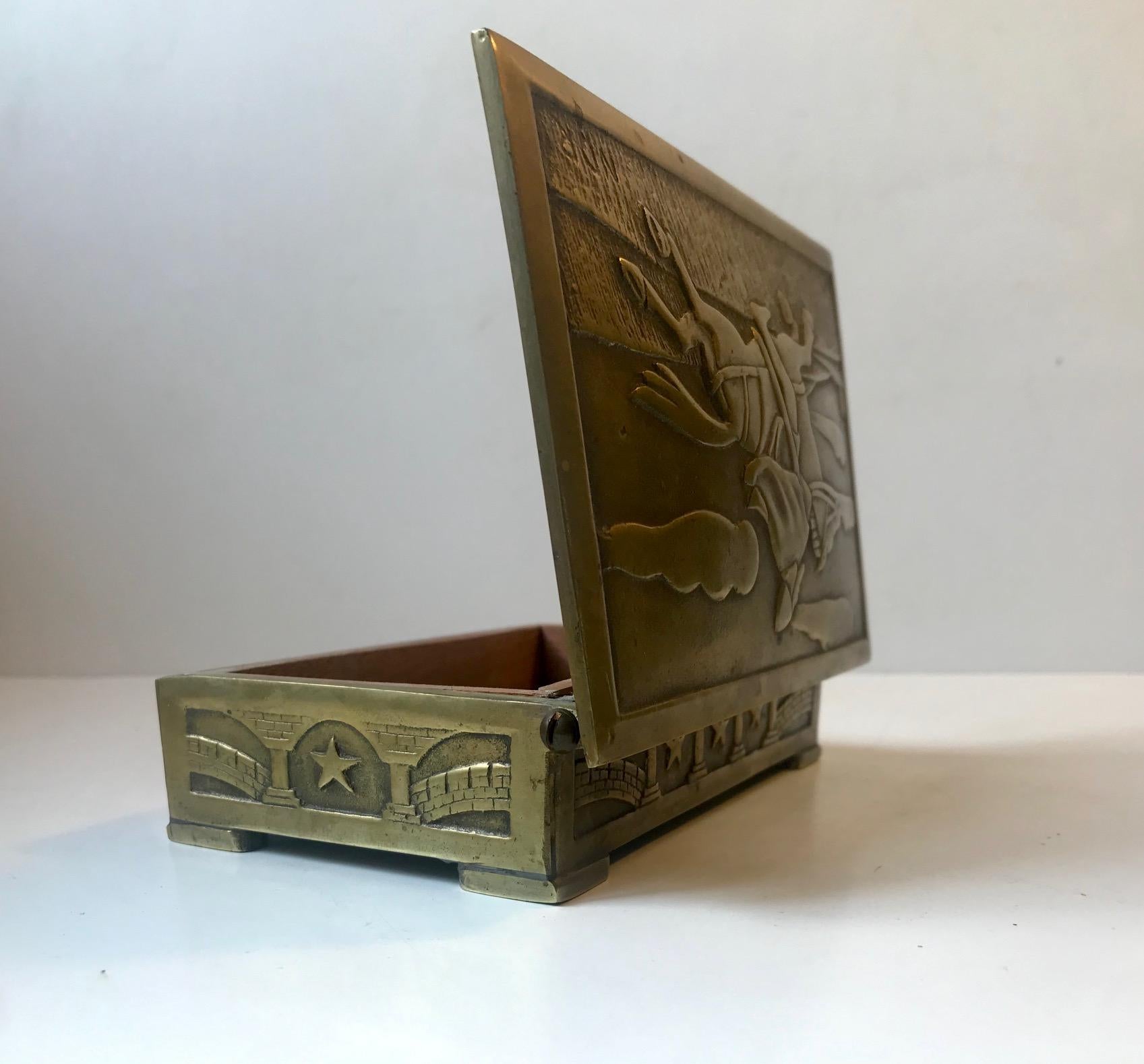 - Heavy Art Deco bronze box with soldier on horse in relief.
- Art deco interpretation of medieval themes
- Clean and strict architectural design despite the Classic motif.
- Golden, rich and original patina
- It was manufactured in Denmark