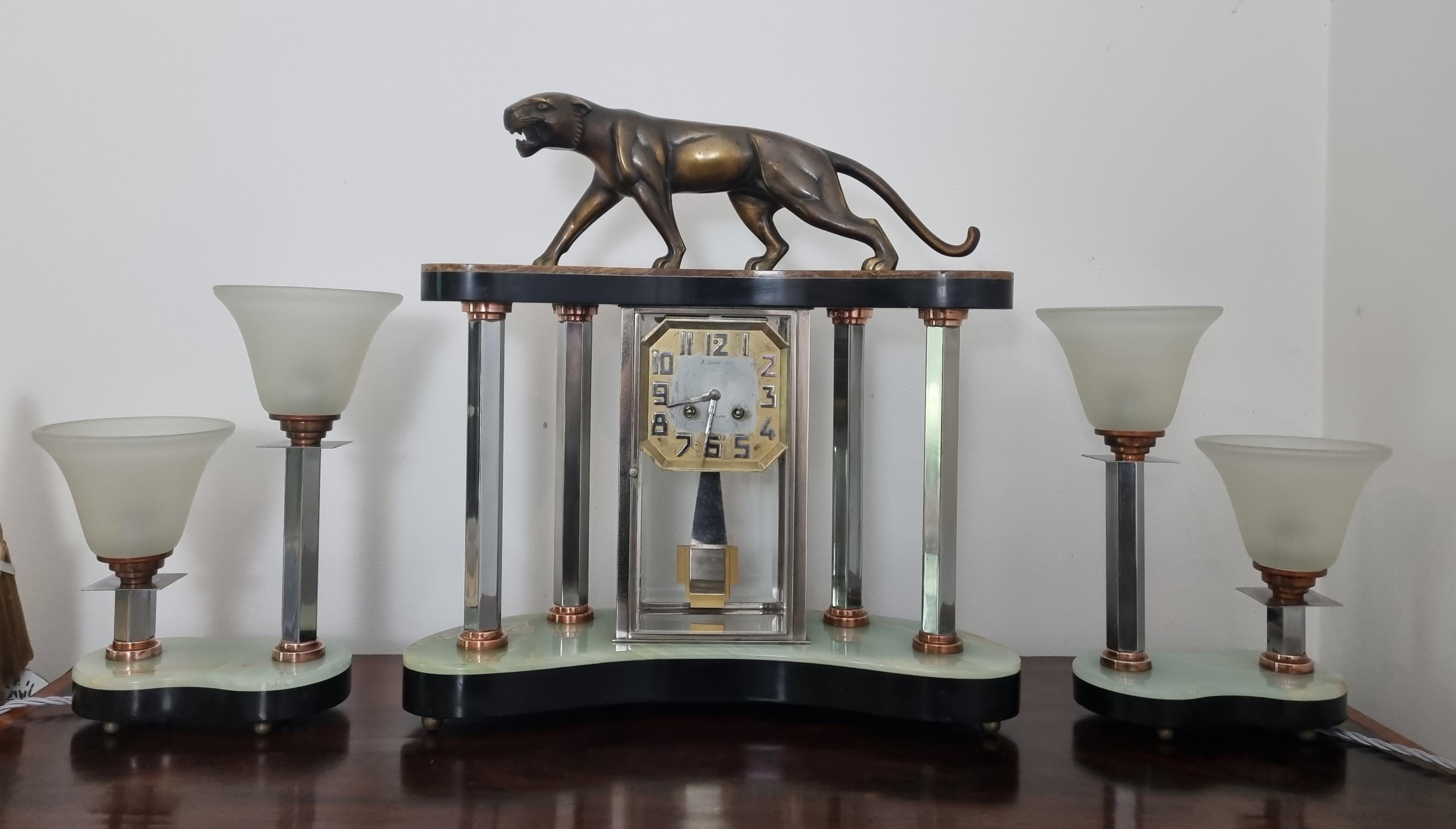 A stunning Art Deco Clock Set with Lamp Garnitures by highly regarded French Sculptor , Jean-Baptiste Hugues , who was working in Paris during the 1920s.
A beautifully designed , solid bronze panther mounted on a marble and onyx plinth , supported