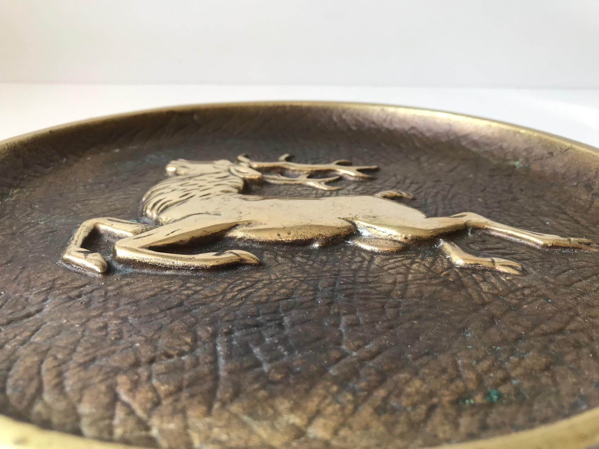 Heavy solid bronze bowl/dish with elephant skin texture and a center-motif of a stylized stag in relief. It was designed and manufactured by Crown in Copenhagen Denmark during the 1930s. The same period Just Andersen took the world by storm with his