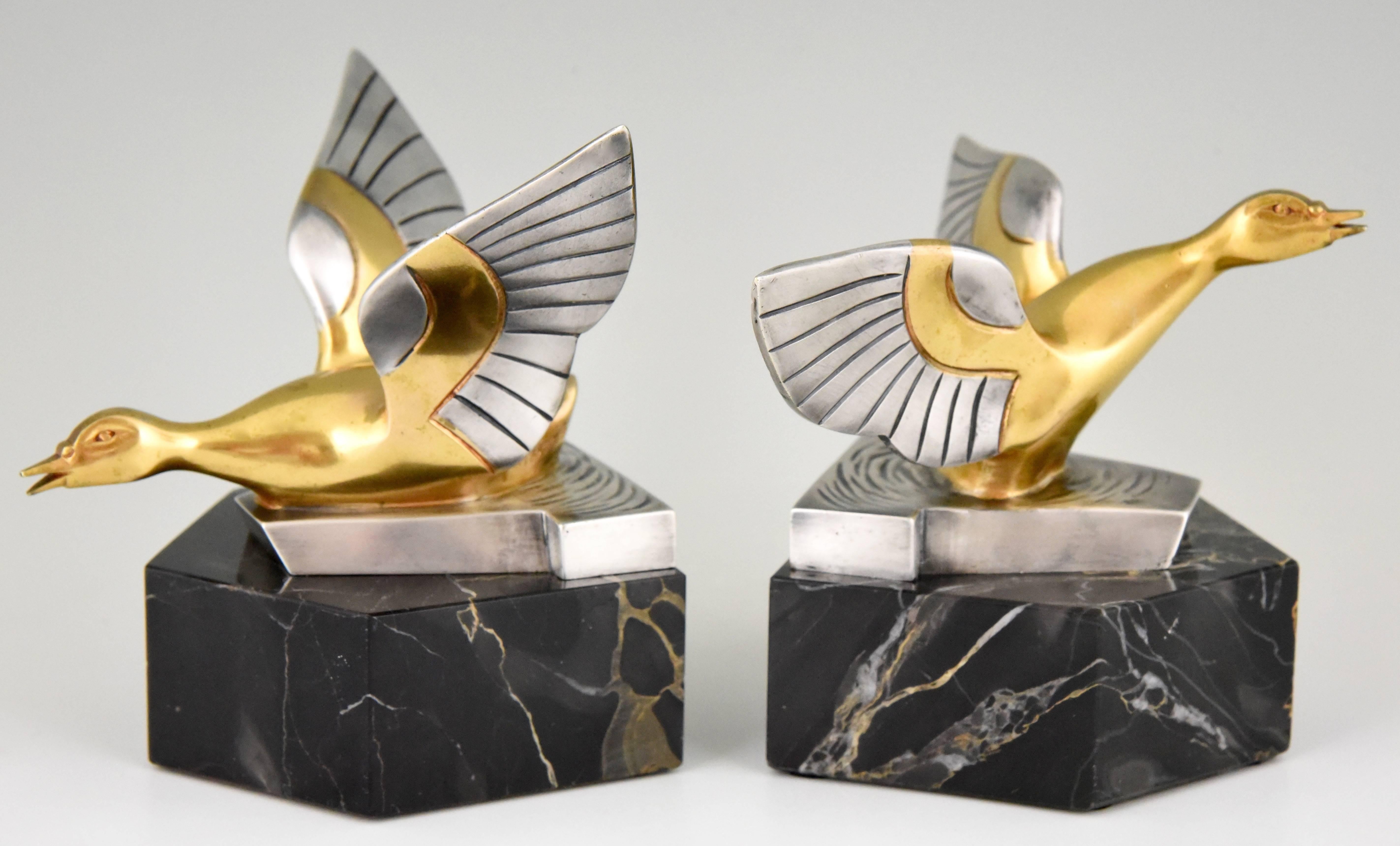 Very unusual pair of gilt and silvered bronze bookends with ducks by the French artist Danvin. The bronzes are mounted on Portor marble bases, 
France, 1930.