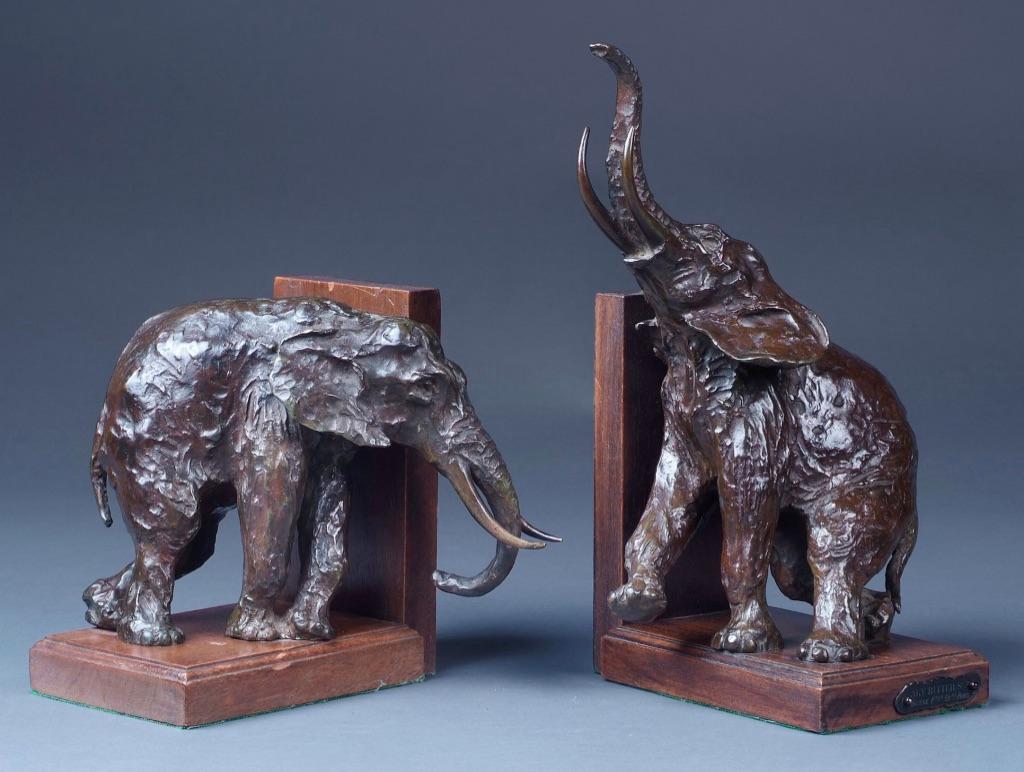 Ary Bitter (1883-1973)-A pair of patinated bronze elephant book-ends, each on wood base and one with inscribed tag, cast by Susse Frères of Paris.