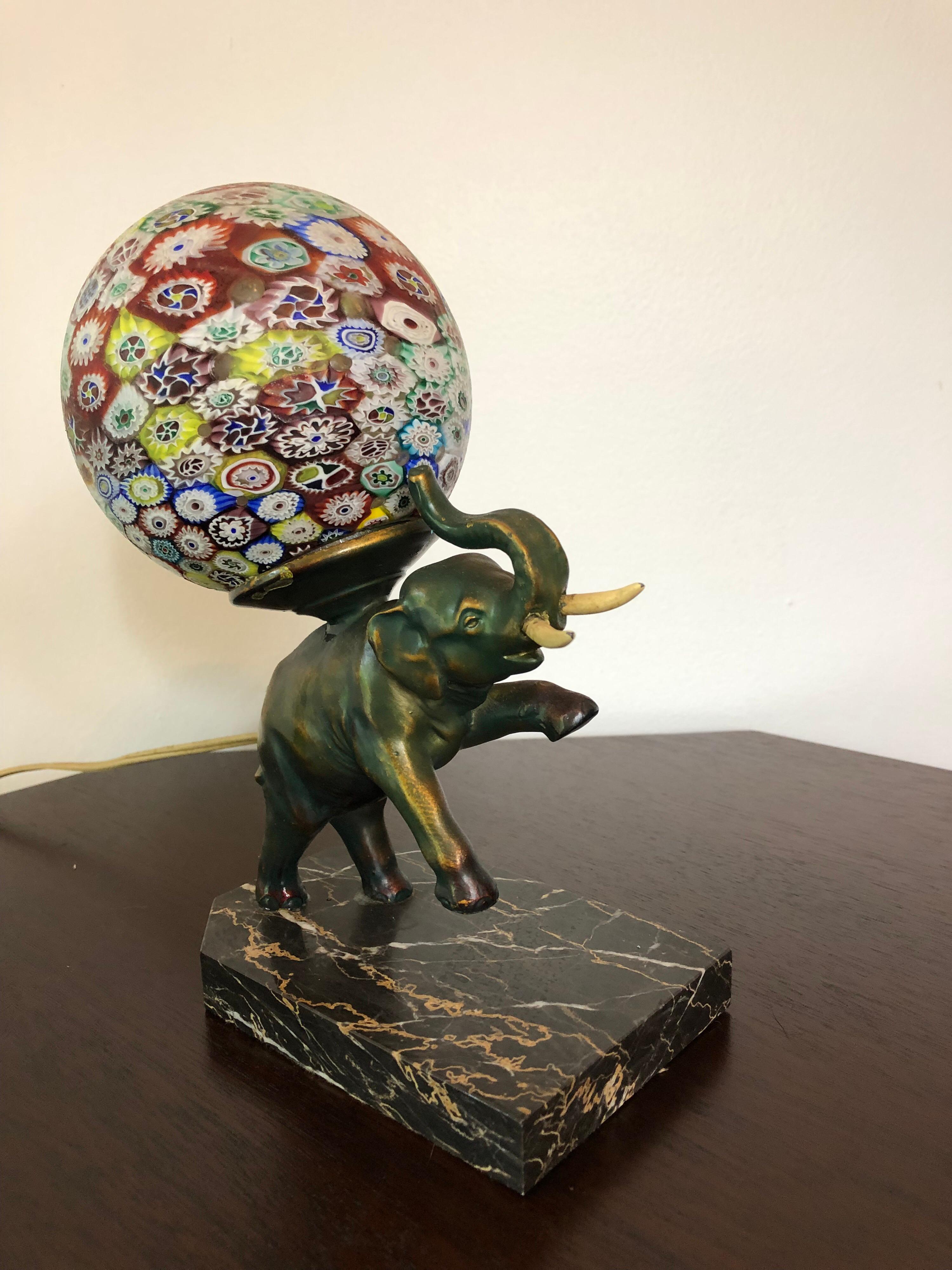 An Art Deco bronze elephant lamp with Murano Millefiori globe. Faux tusks and mounted on a marble base.
