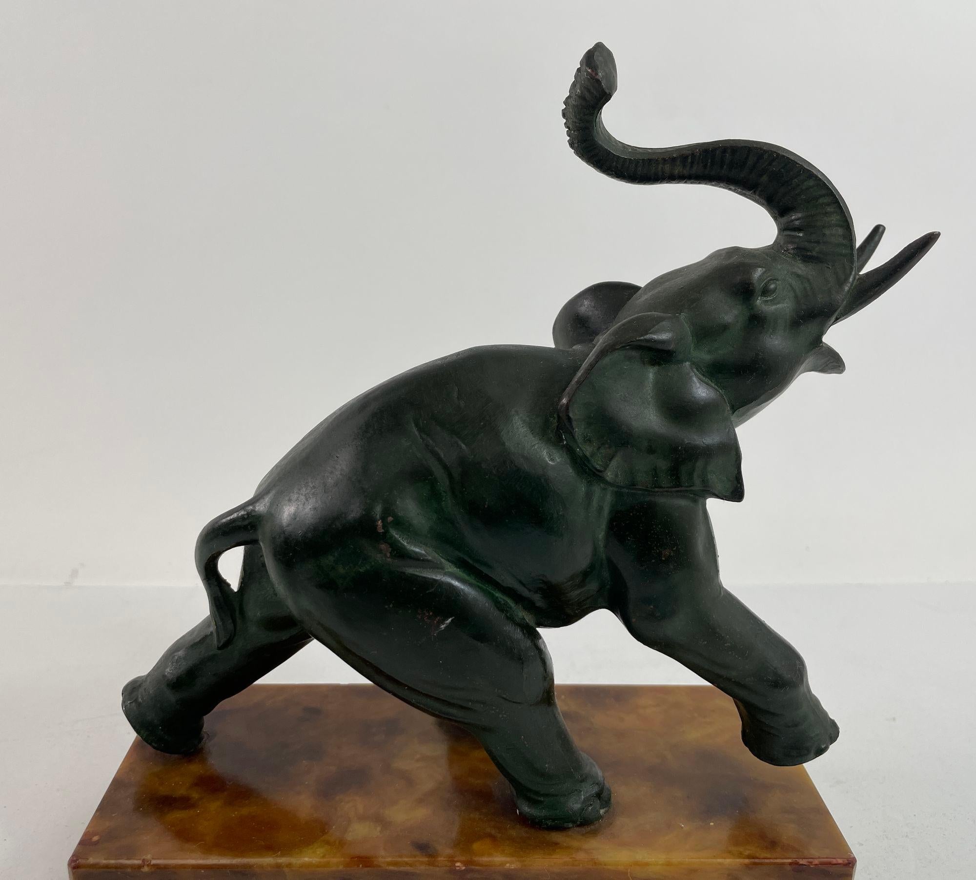 Art Deco Bronze Elephant Sculpture Italy.
Impressive bronze Art Deco sculpture of an elephant in dark green cast bronze on brown marble base.
Elephant with raised trunk on marble base.
Green felt on bottom with paper tag 