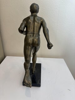 Art Deco bronze figure of a man wearing a loin cloth running