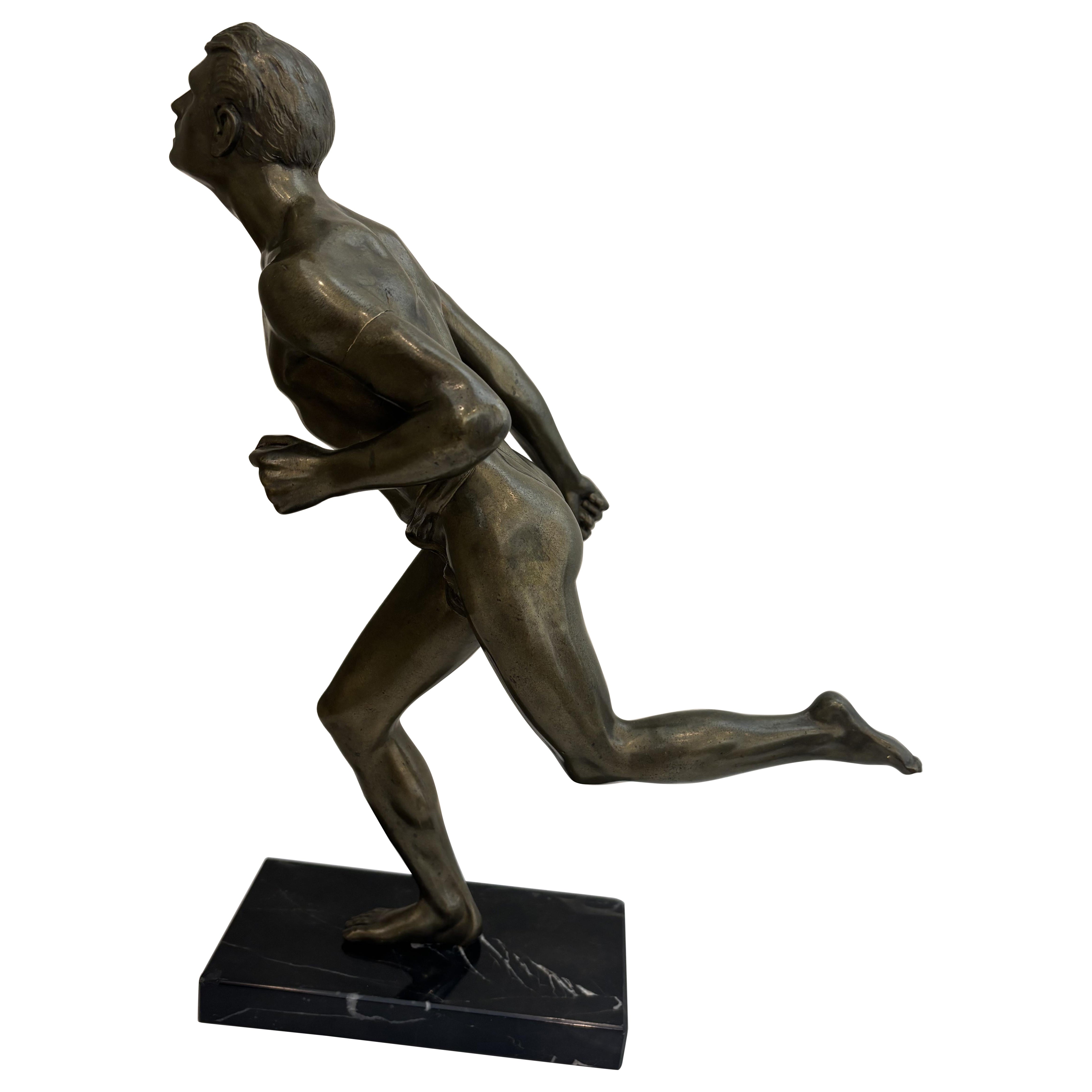 Art Deco bronze figure of a man wearing a loin cloth running en venta