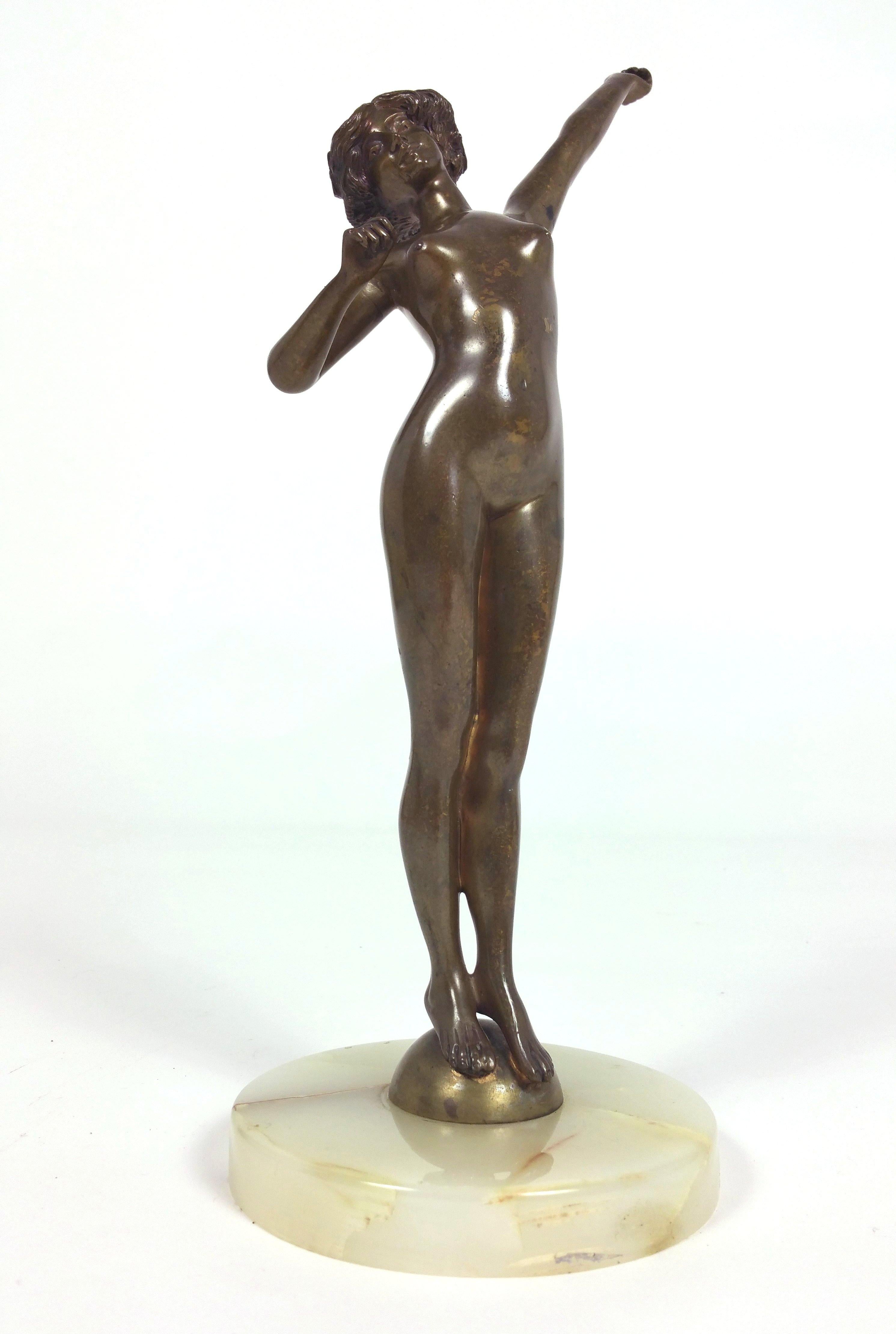 This graceful and delicately poised Art Deco bronze sculpture depicts an attractive nude maiden in a languidly upright outstretched position. The sculpture is titled ‘Awakening’ and rests on an onyx base, which is unsigned. It measures 5 in – 12.7