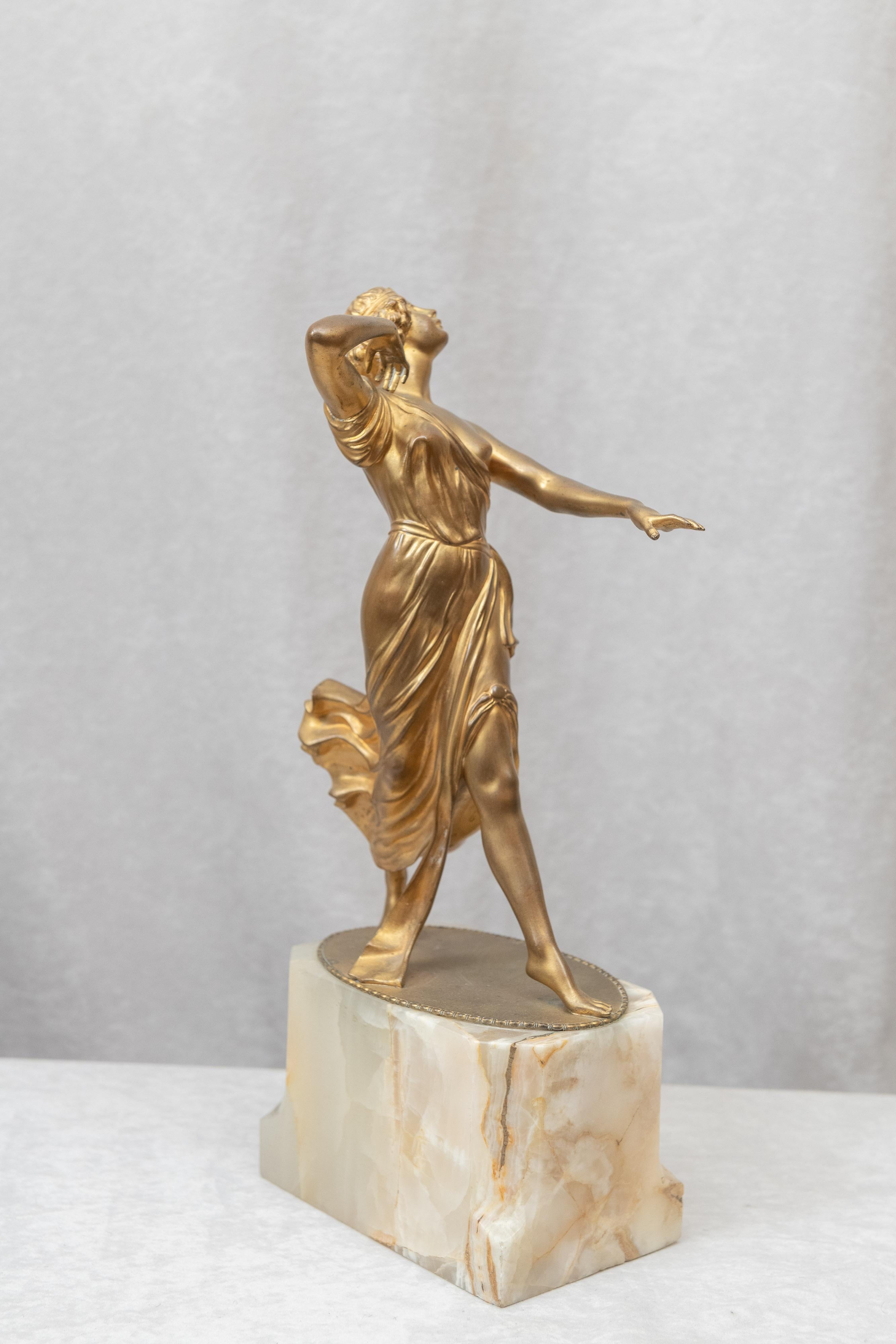If you like Art Deco, this bronze should appeal to you. This graceful dancer retains her original gilt finish and is mounted on a beautiful onyx base. Artist-signed A. Ermler. A listed German artist of the Art Deco period. One really unusual and