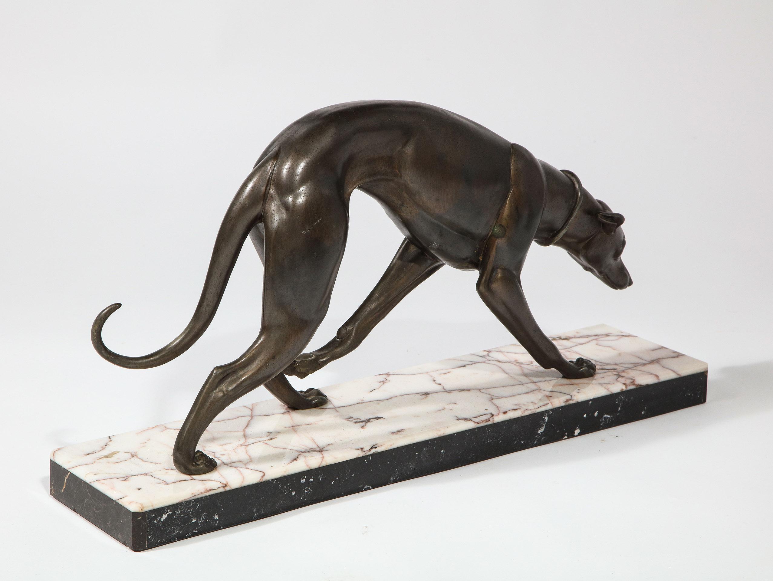 The bronze greyhound on a multicolored marble base.