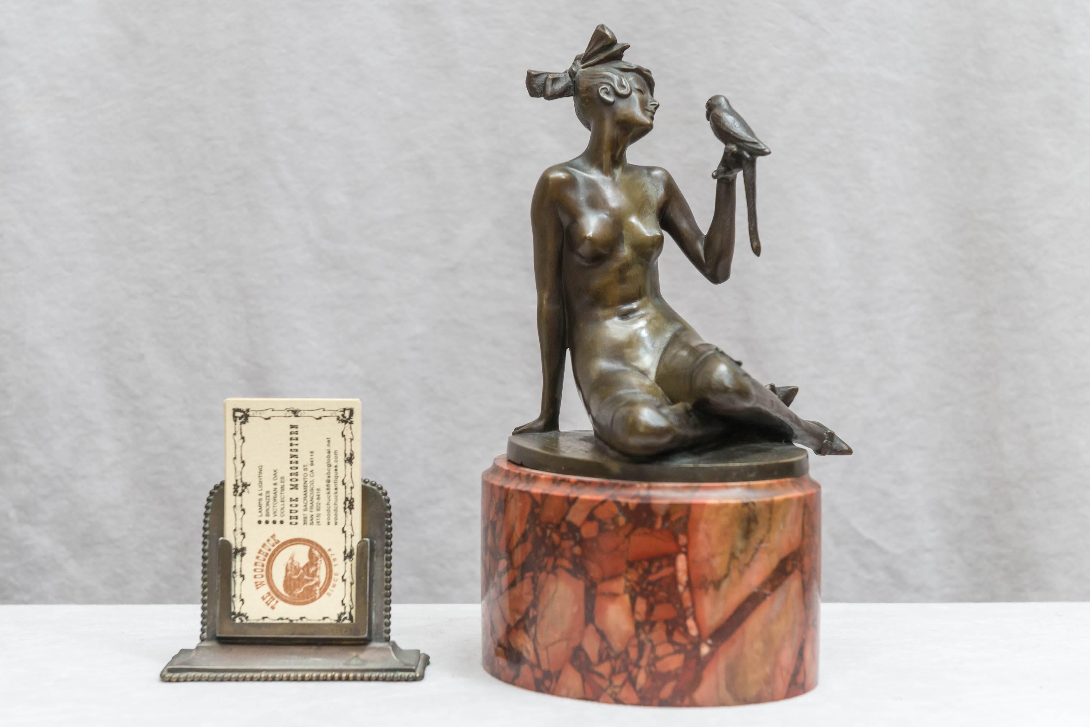 This shapely gal is enjoying her conversation with her little bird. Pure art deco period and style and mounted on a colorful red rouge marble base. Fine casting and rich warm brown patina. Artist signed Elischer. For examples of his works please