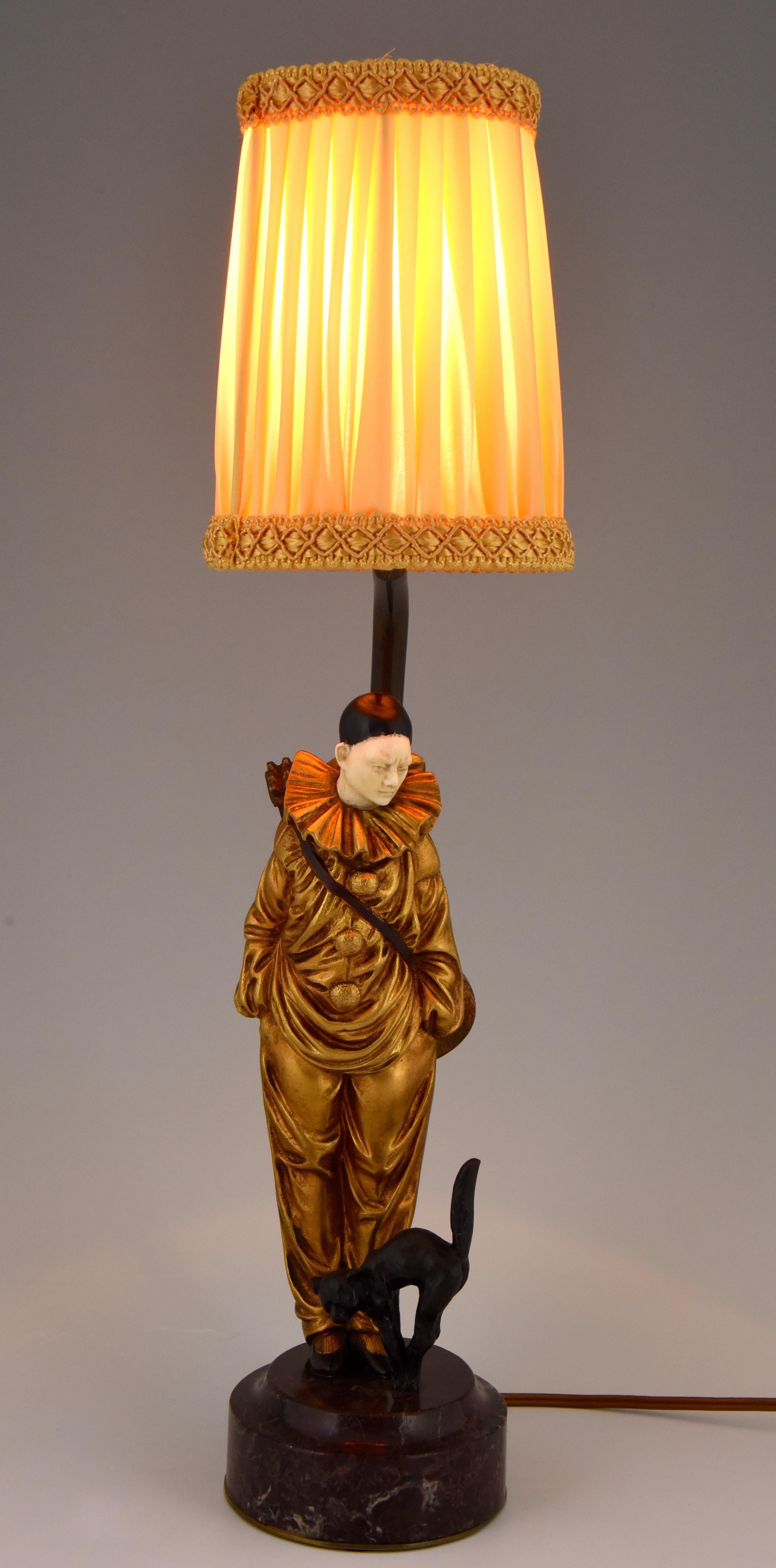 Cute bronze table lamp with a sculpture of a Pierrot clown and his cat. The lamp is signed by Georges Omerth and has a lovely gilt patina, France 1925. The lampshade is in fabric and gives a warm ambient light.
This bronze is illustrated in:?

