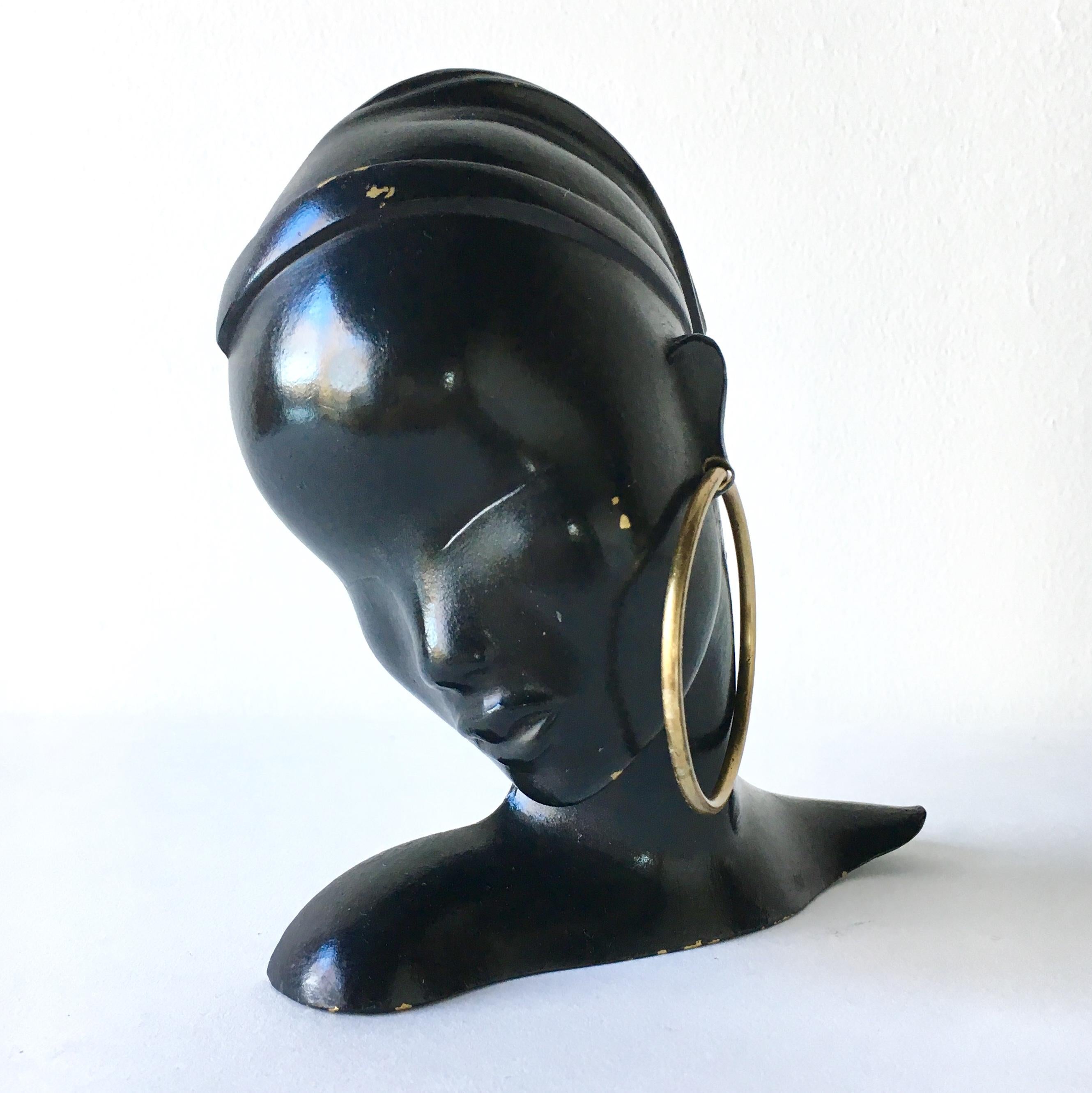 An Art Deco ebonised bronze mask of female form by Hagenauer, stamped Austria

Hagenauer Werkstatten was founded by Carl Hagenauer an Austrian designer in 1898 and continued by his sons Franz and Karl Hagenauer from 1928–1986. The majority of