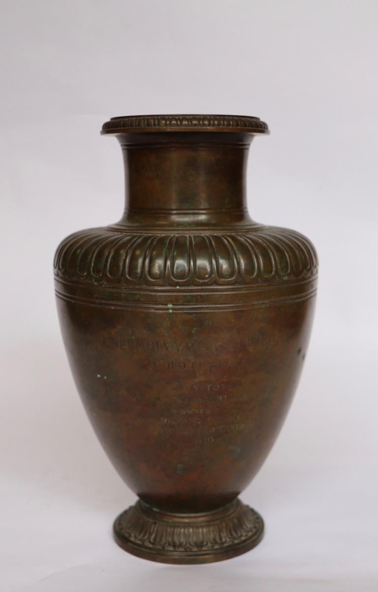 Extraordinary bronze trophy by Tiffany & Company. Vase bears the following inscription:
COLUMBIA YACHT CLUB TROPHY GOLD CUP RACE WON BY HOTSY TOTSY MONTAUK YACHT CLUB OWNED BY RICHARD F. HOYT VICTOR KLIESRATH 1930. Marked on verso Tiffany and