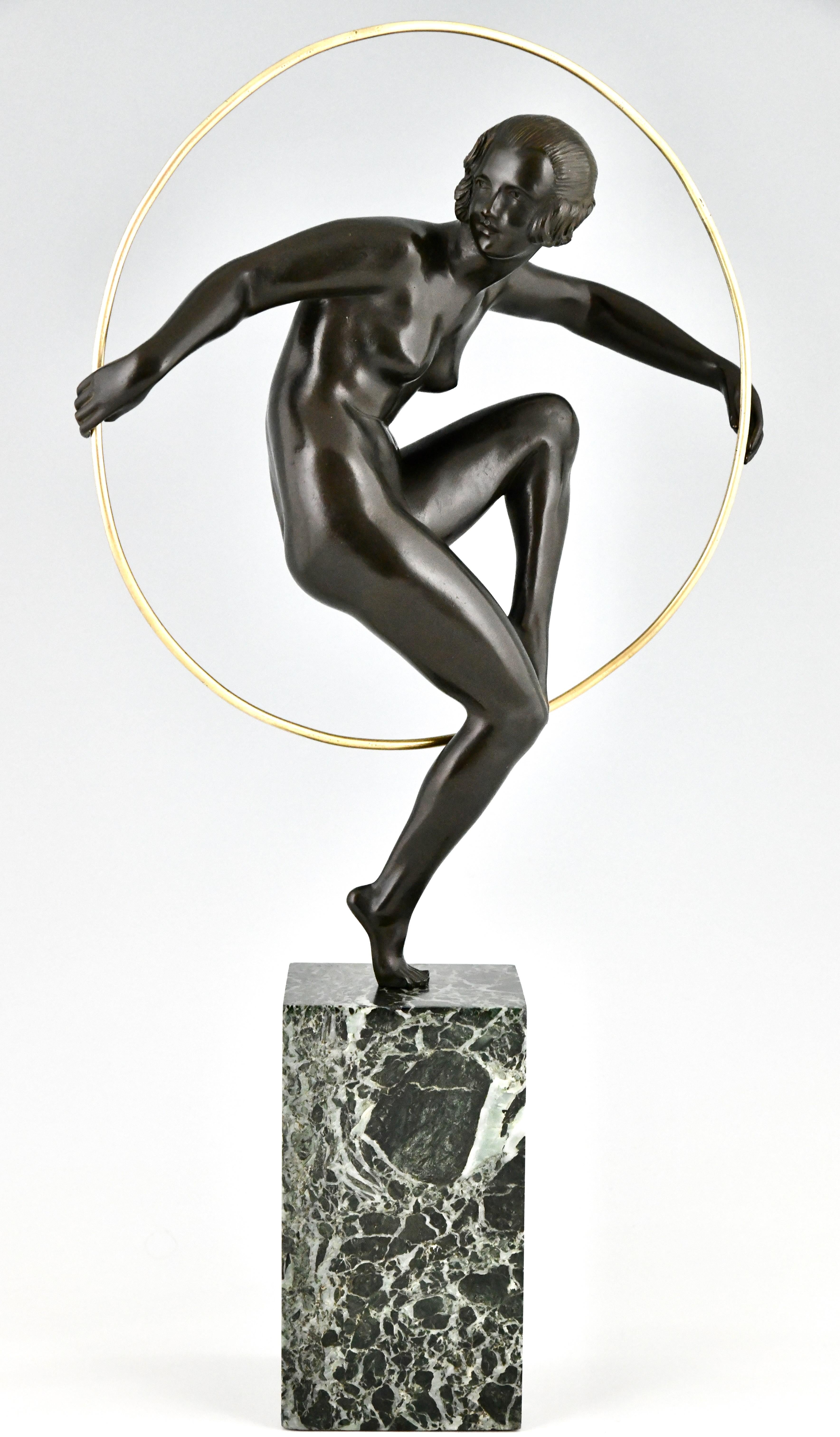 Art Deco bronze nude hoop dancer by Marcel André Bouraine. 
Bronze with green patina on a green marble base. 
France ca. 1930.
This bronze illustrated on page 44 of the book
Art Deco and other figures, Brian Catley.