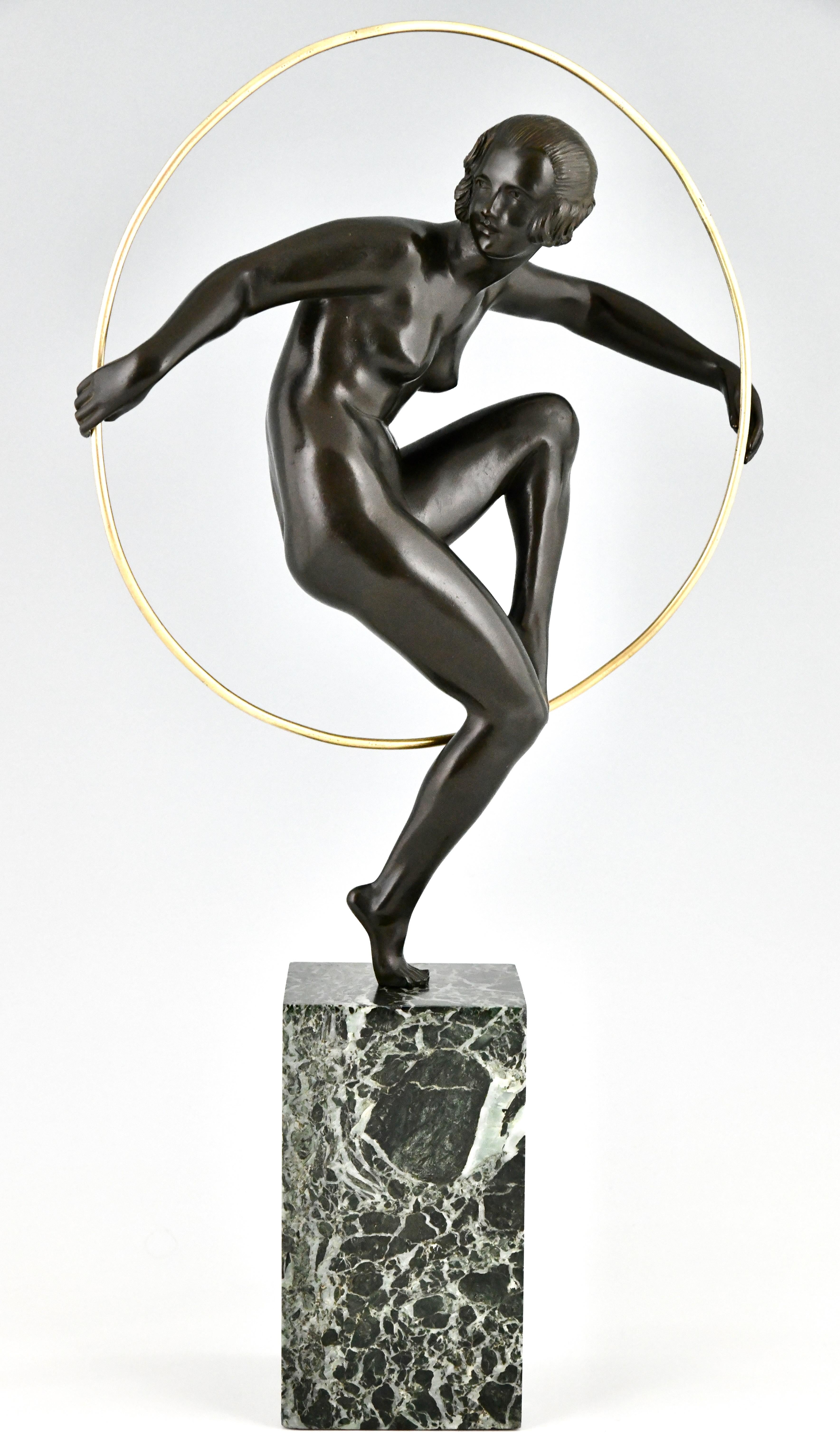 Art Deco bronze nude hoop dancer by Marcel André Bouraine. 
Bronze with green patina on a green marble base. 
France ca. 1930.
This bronze illustrated on page 44 of the book
Art Deco and other figures, Brian Catley.