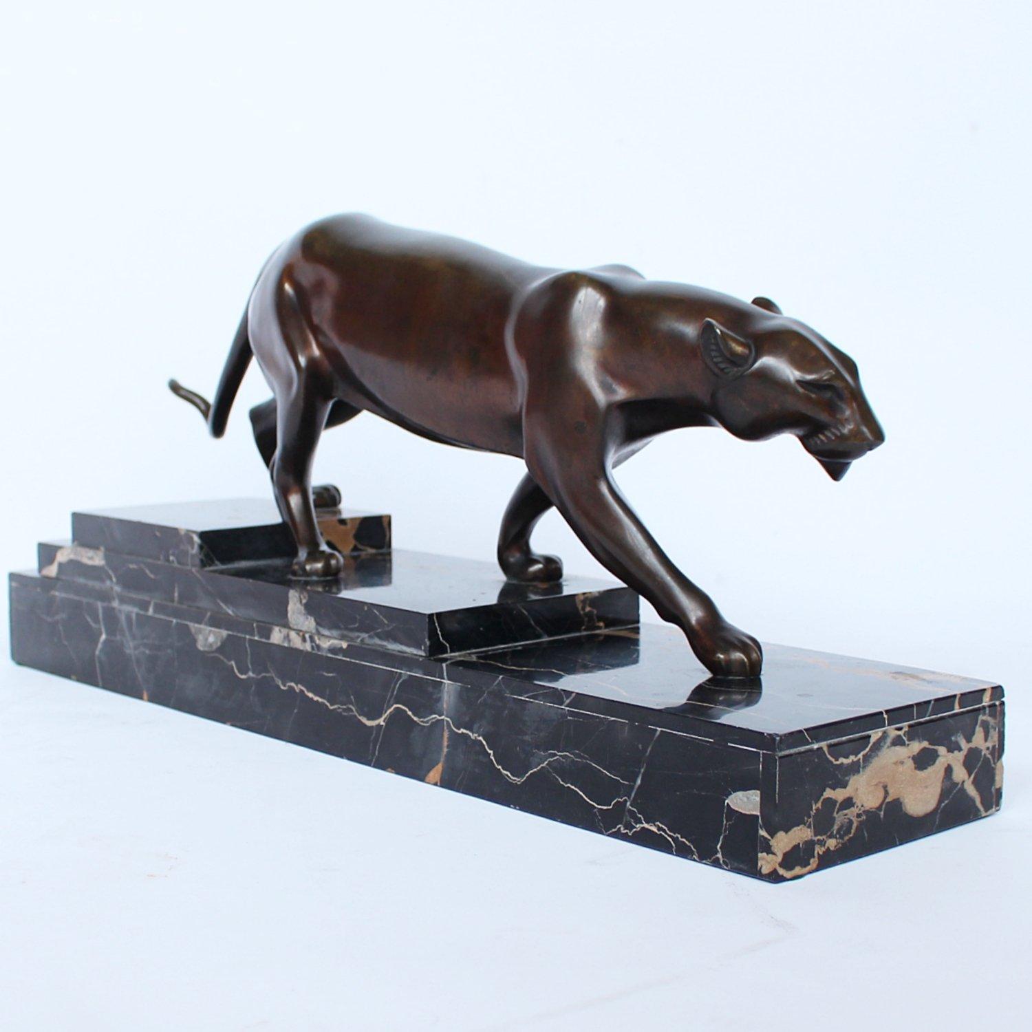 An Art Deco, patinated bronze study of a prowling panther, set over an integral marble base. Signed H Molins to marble and cast and stamped with foundry mark to cast. 

Artist: Henri Molins.

 