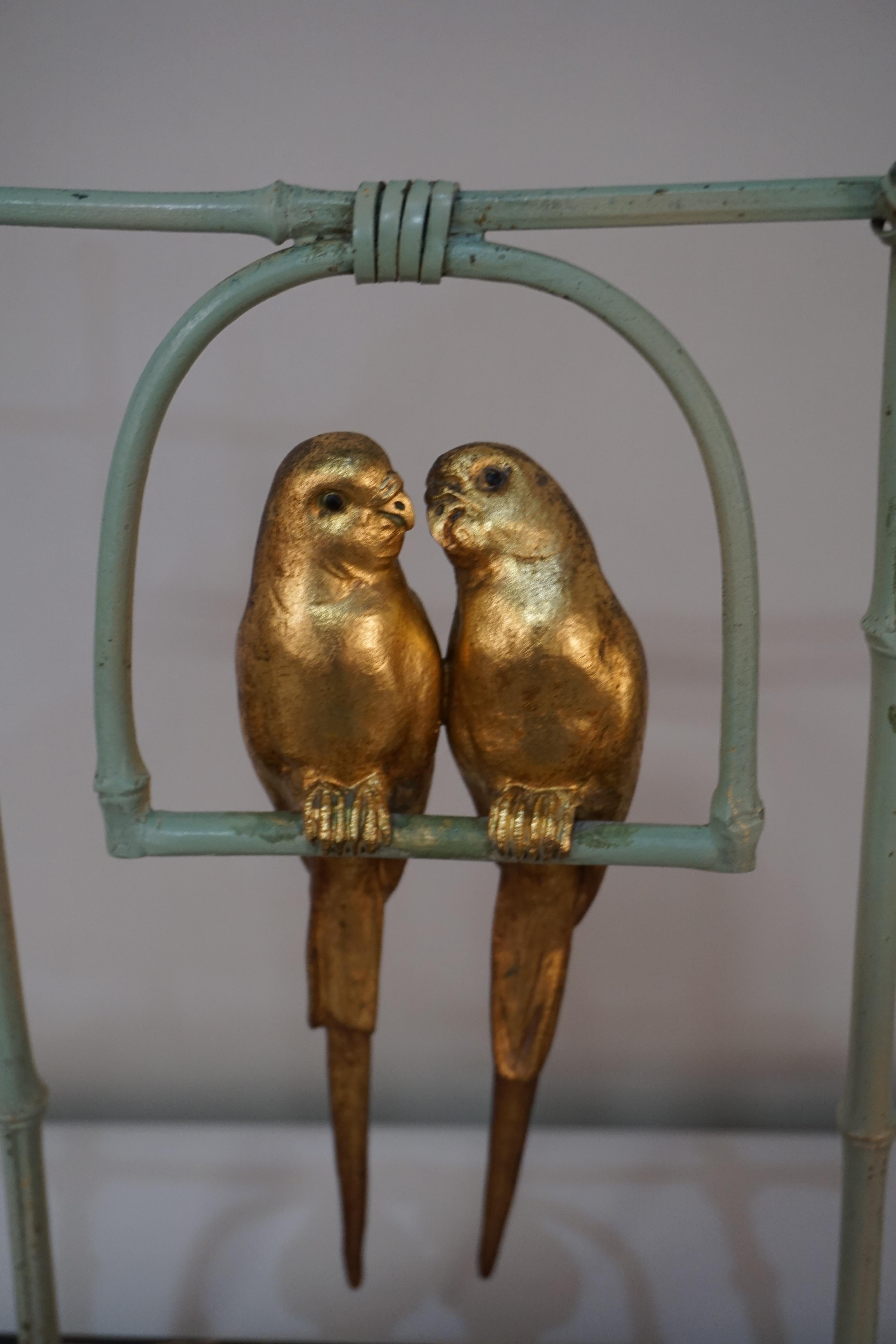 Bronze parakeets on swing by A. Van Kote.