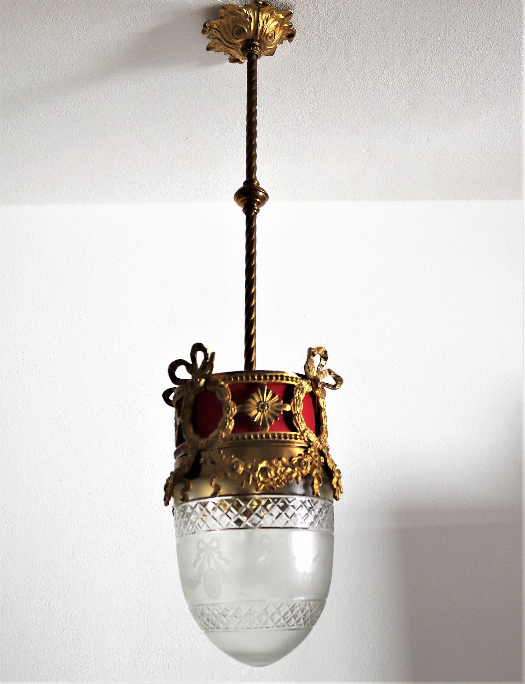 Gorgeous antique lantern made of heavy bronze and beautiful crystal cut glass with red textile inlet,
Made in the 1950s, Italy.
Bronze canopy and bar to the ceiling.
The lamp is in original shape and in very good vintage and working condition.
No