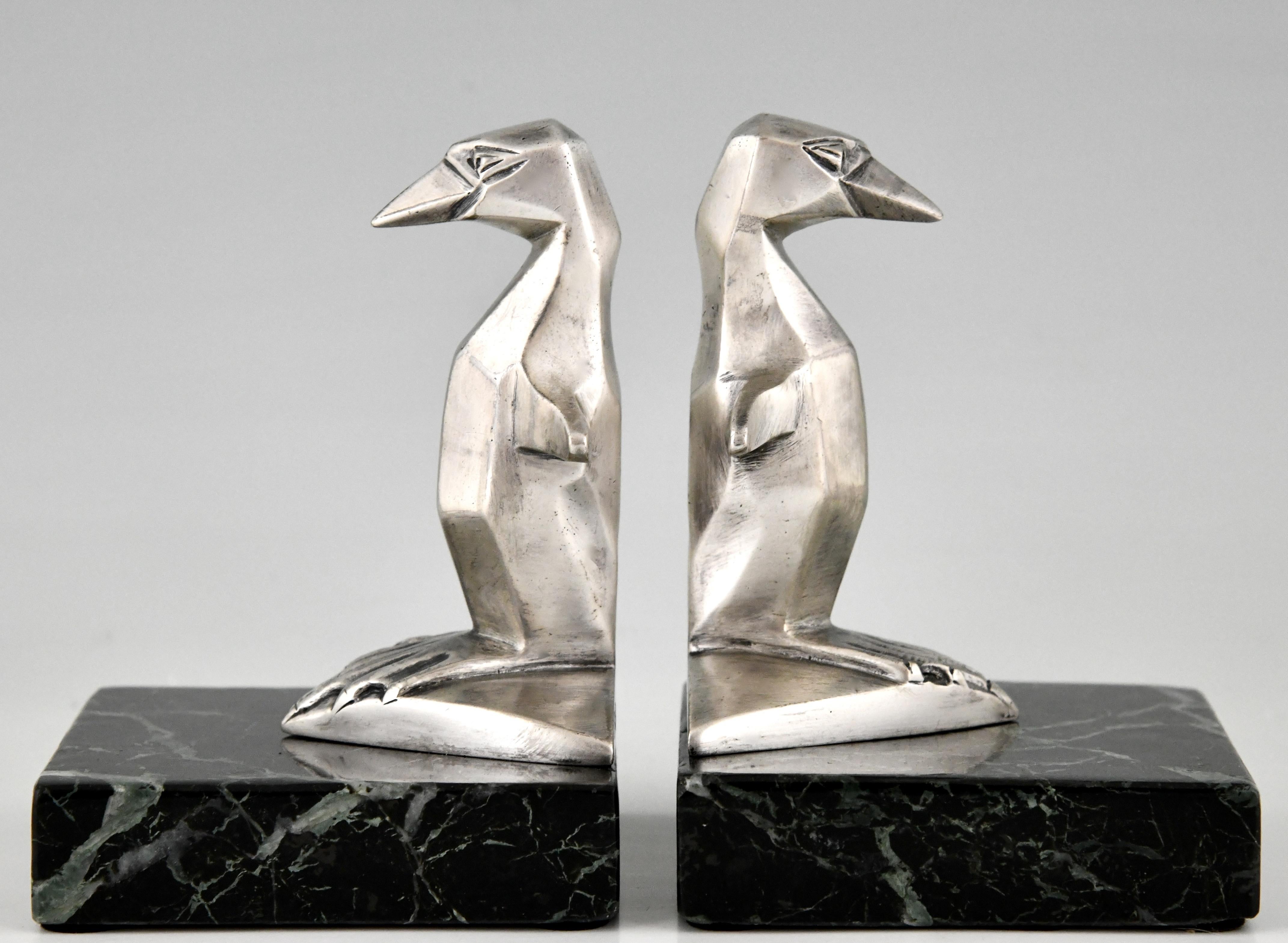 Art Deco silvered bronze bookends with penguins on marble bases. 
Signed by Gaston H Bourcart. France 1930.
Literature:
“Mascottes passion” by Michel Legrand, Antic show éditions. ?“Mascottes automobiles” by Michel Legrand, EPA éditions. ?