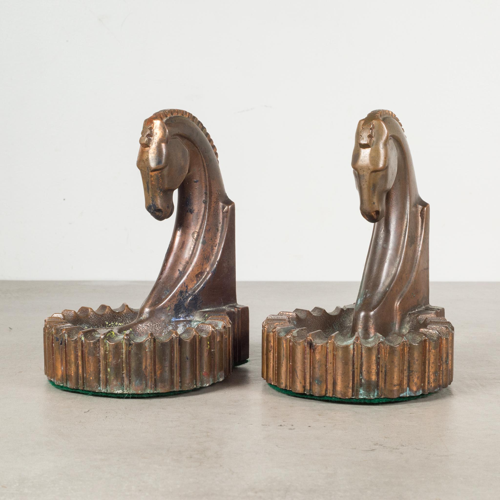 About

This is an original pair of Art Deco style cast metal Trojan horse bookends with ashtray on one side and pipe holder on the other. Manufactured by either Dodge or Champion Products, Los Angeles USA. Both pieces have retained their original