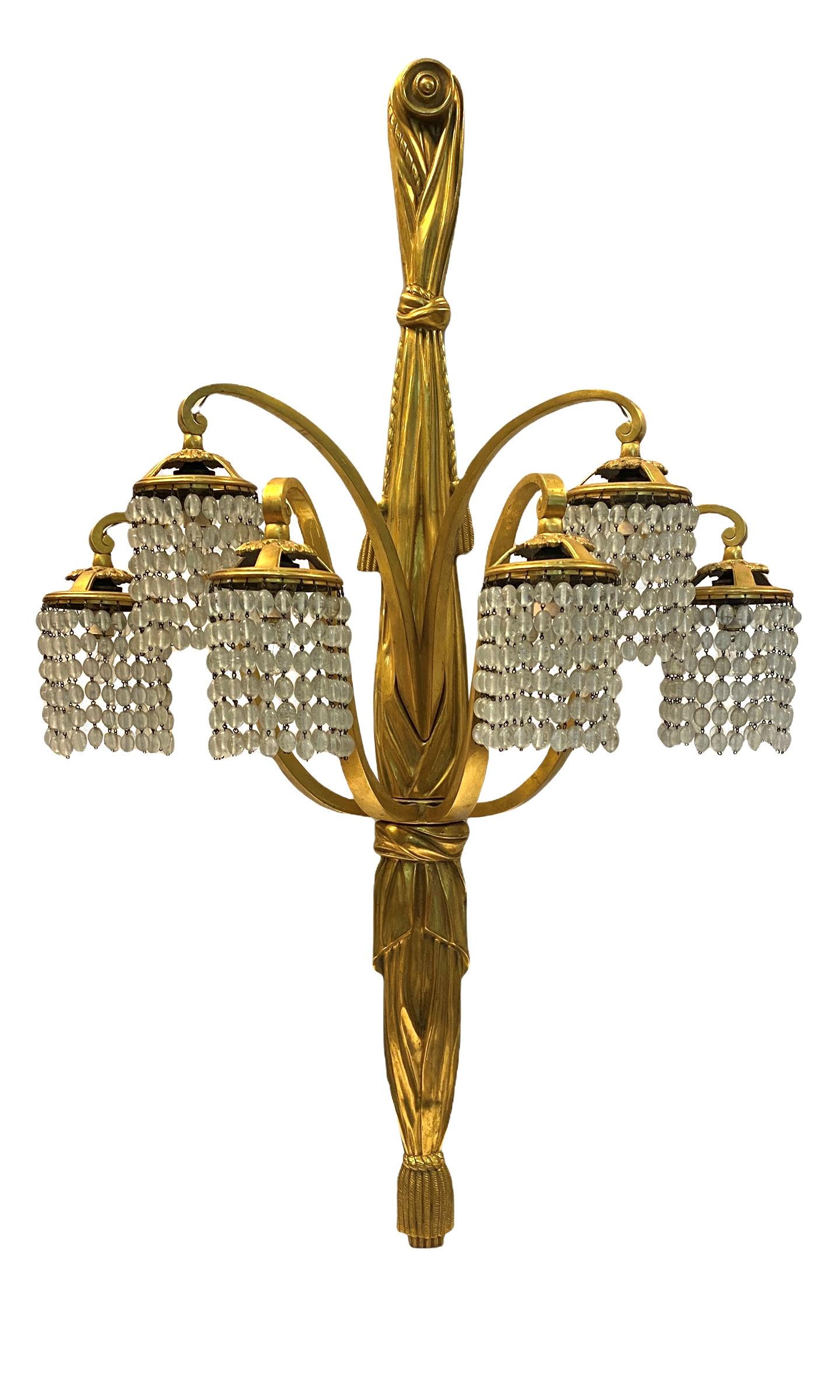 Our rare set of four gilt bronze sconces with knotted drapery motif with crystal beads are attributed to Louis Süe (1875-1968) and André Mare (1885-1932) for their firm, Compagnie des Arts Français. Each 40.5 by 23 by 11 inches, apparently unsigned,