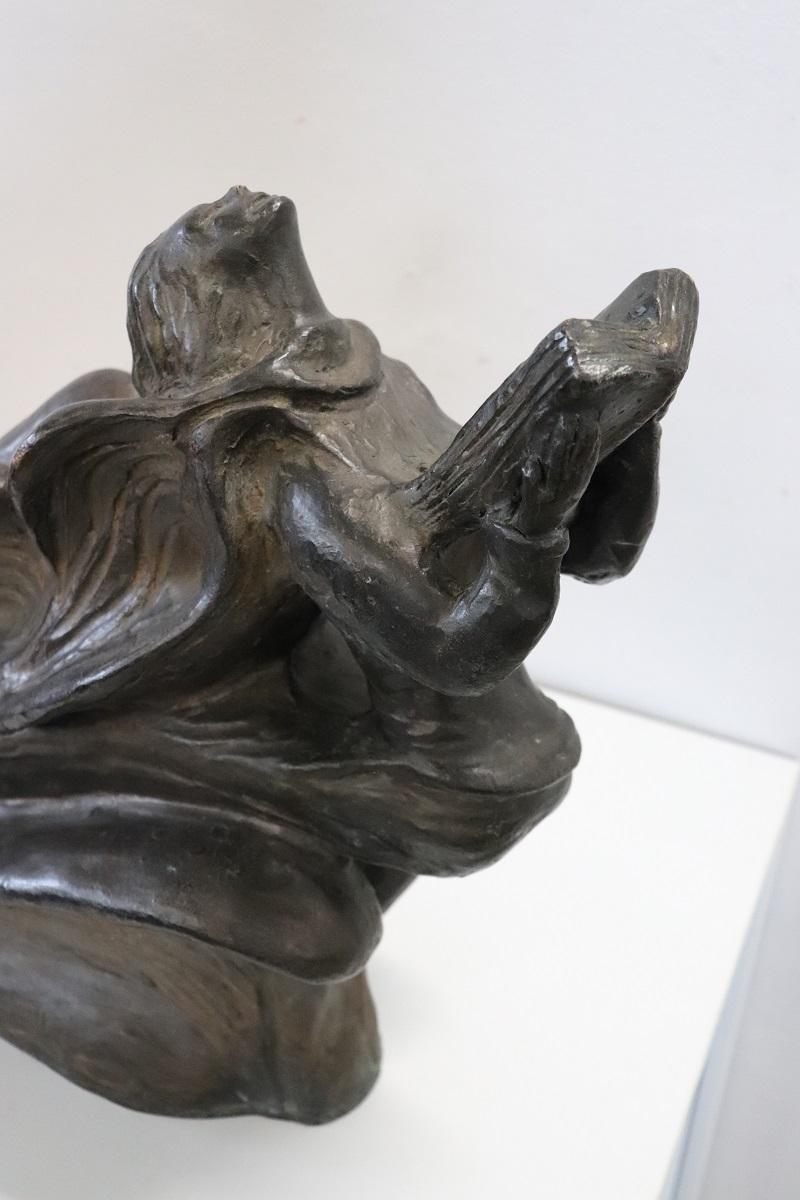 This Art Deco bronze sculpture is captivating and full of symbolism. The angel's dynamic pose with large wings suggests movement and aspiration, evoking emotions of hope and enlightenment, especially with the presence of a book, which could