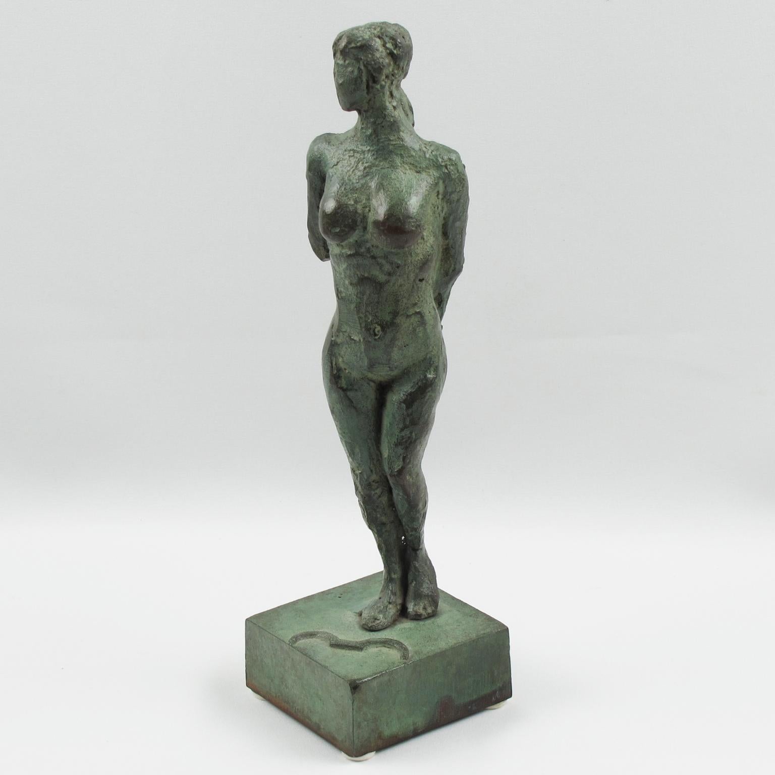 This stunning French Art Deco bronze sculpture or figurine features a stylized free interpretation of Artemis or Diana, the Huntress (Diane Chasseresse). The nude female statue has a handmade feel and textured pattern design. Both arms are behind