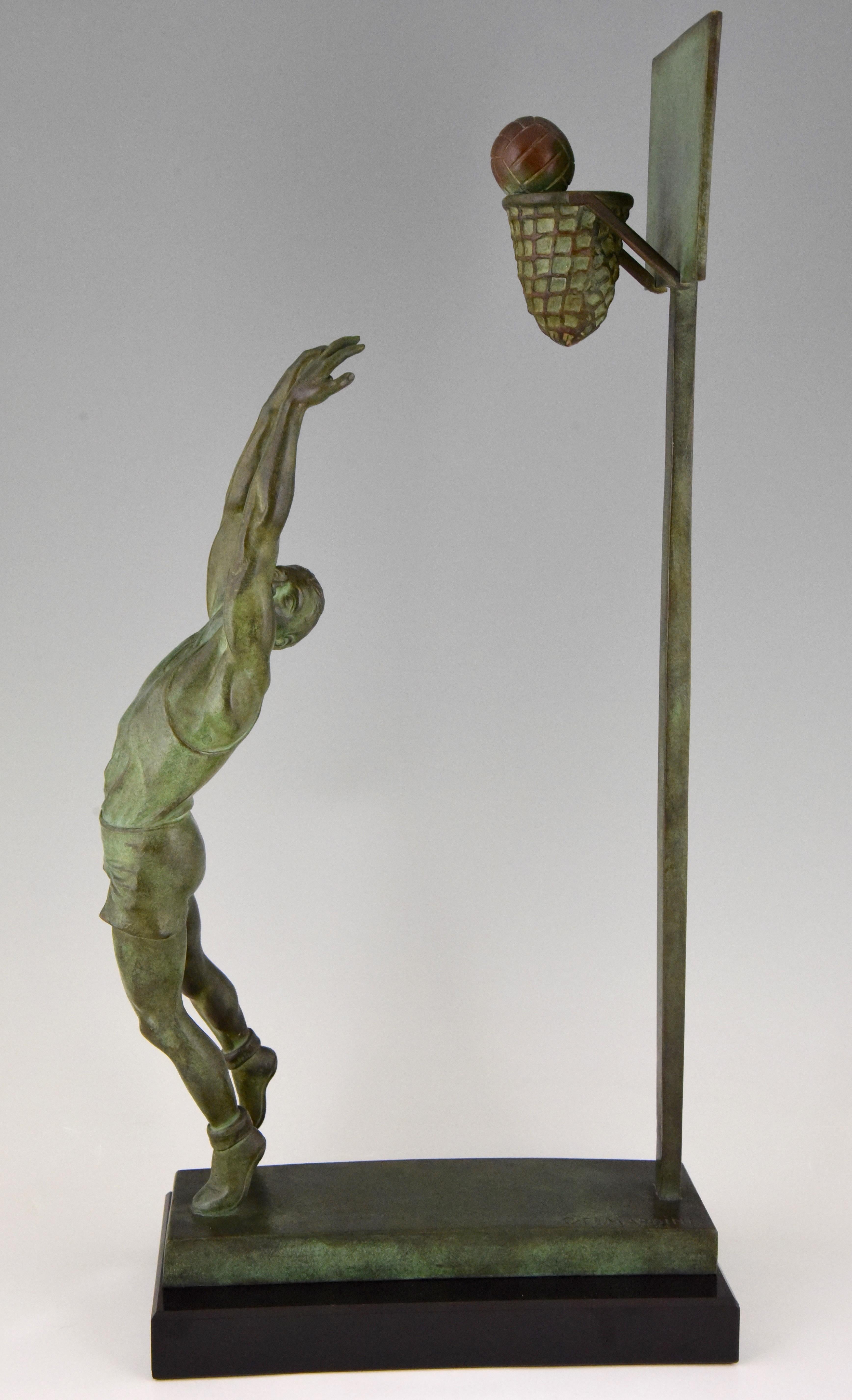 Hard to find Art Deco bronze sculpture of a basketball player doing a reverse dunk. Signed by the artist G.E. Mardini. Beautiful green patina on a Belgian black marble base. France, circa 1930.
