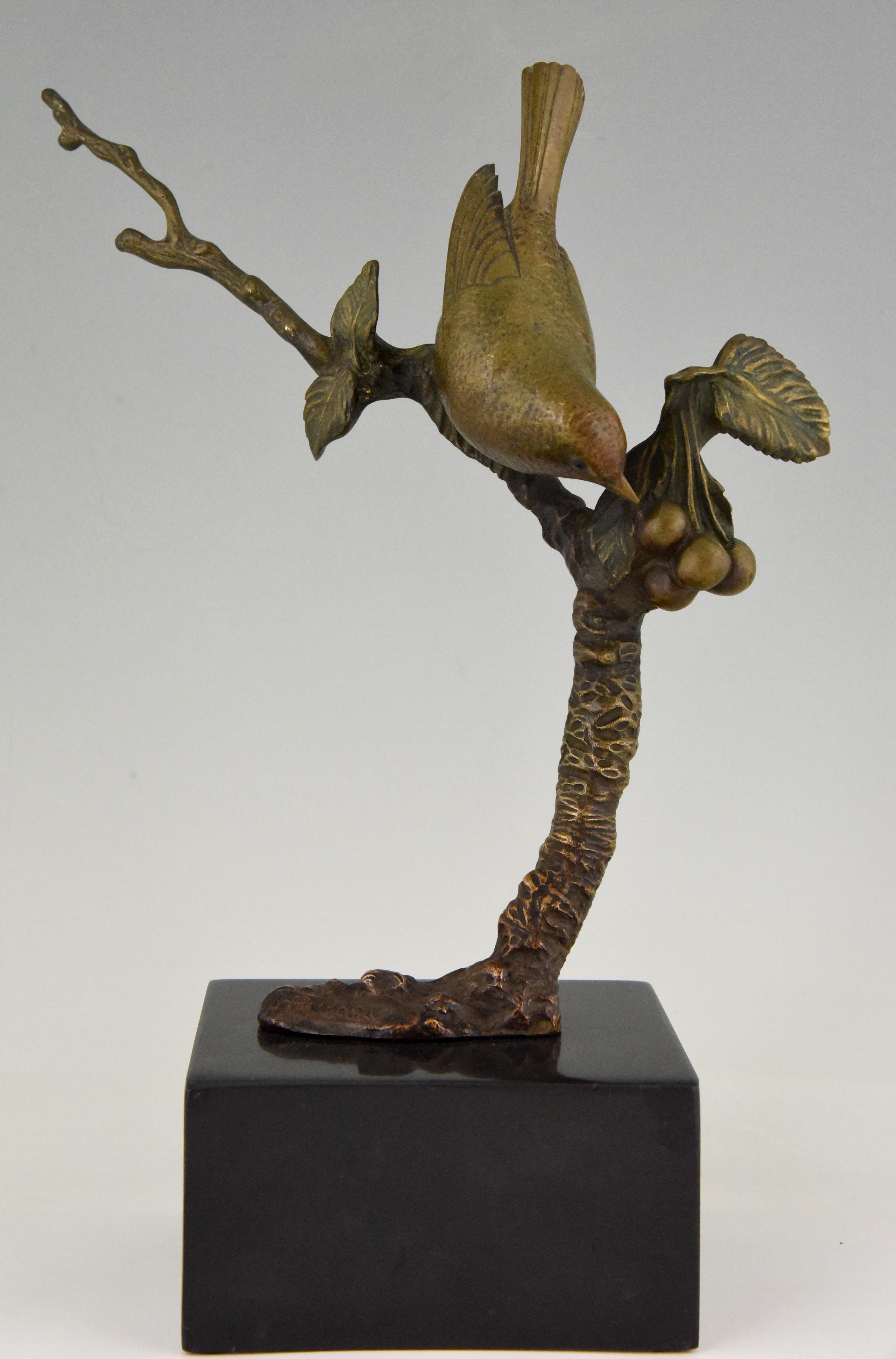 Cute Art Deco bronze sculpture of a bird on a branch with berries. Signed by the French artist Irenee Rochard, circa 1930. The bronze stands on a Belgian black marble base and has a lovely patina.
