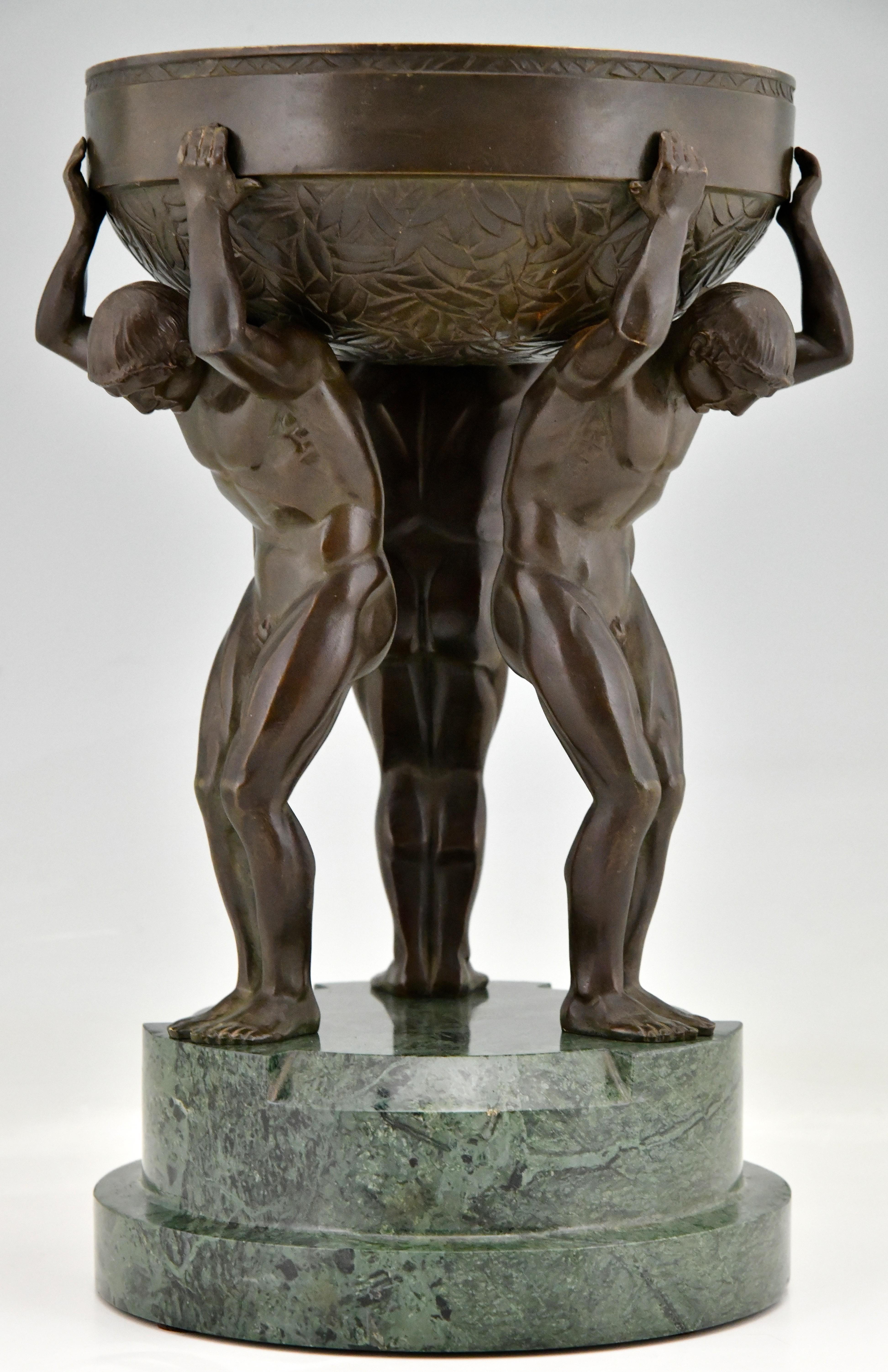 Art Deco bronze sculpture centerpiece with three men signed by Maurice Guiraud Rivière. Bronze, green patina. Green marble base. France 1930. Hard to find Art Deco bronze sculptural centerpiece with a beautiful patina, consisting of a spherical dish