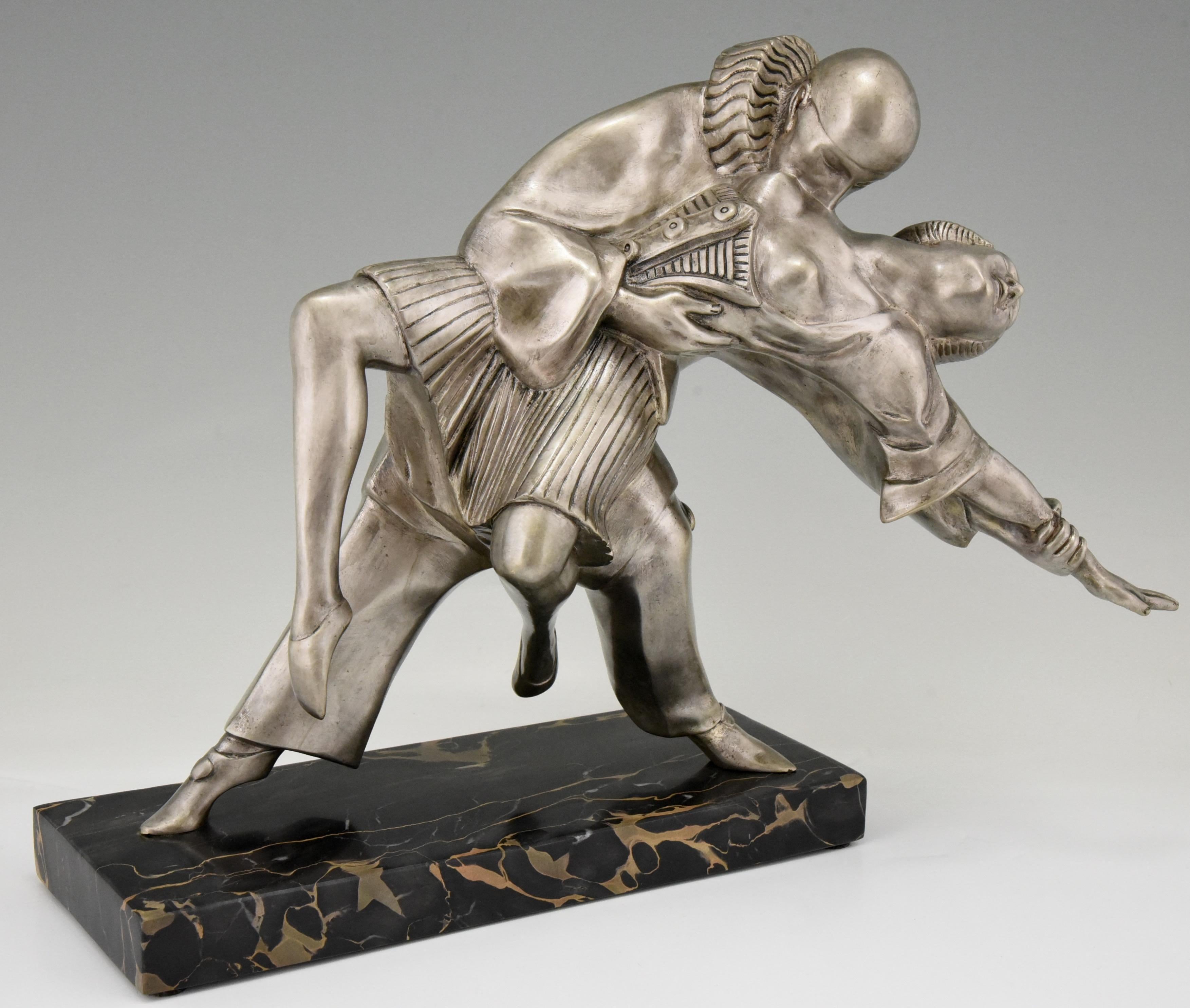 Tango, an Art Deco bronze sculpture of cubist dancers Pierrot and Colombine by Thomas Cartier, France, 1930.
The bronze has a silver patina and stands on a Portor marble base.

