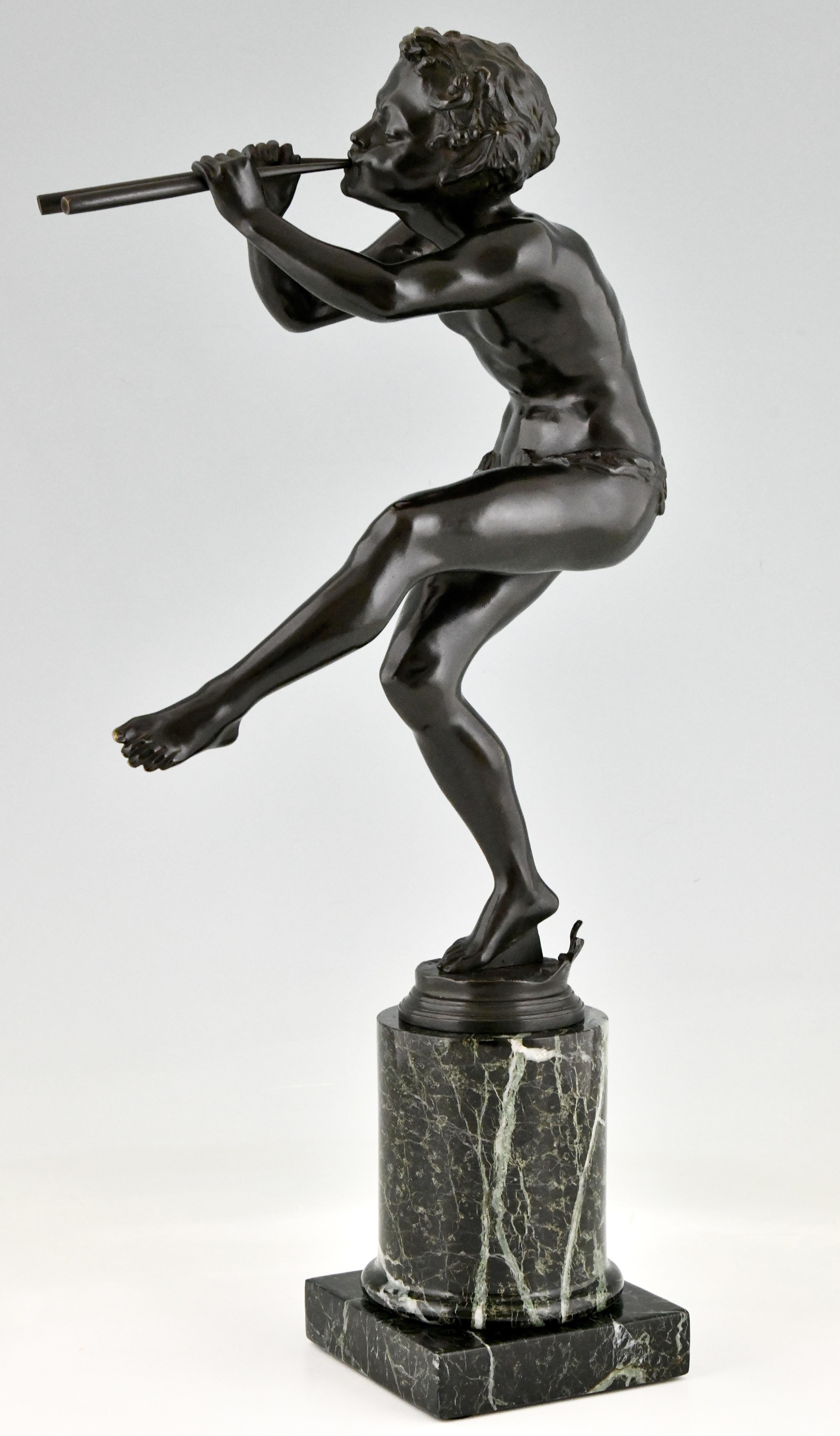 Art Deco bronze sculpture dancing faun with flutes by Edouard Drouot. 
Bronze with dark green patina on green marble base. France 1920
Literature:
Art Deco and other figures by Brian Catley, Antique collectors club.
Les bronzes de XIXe siècle by