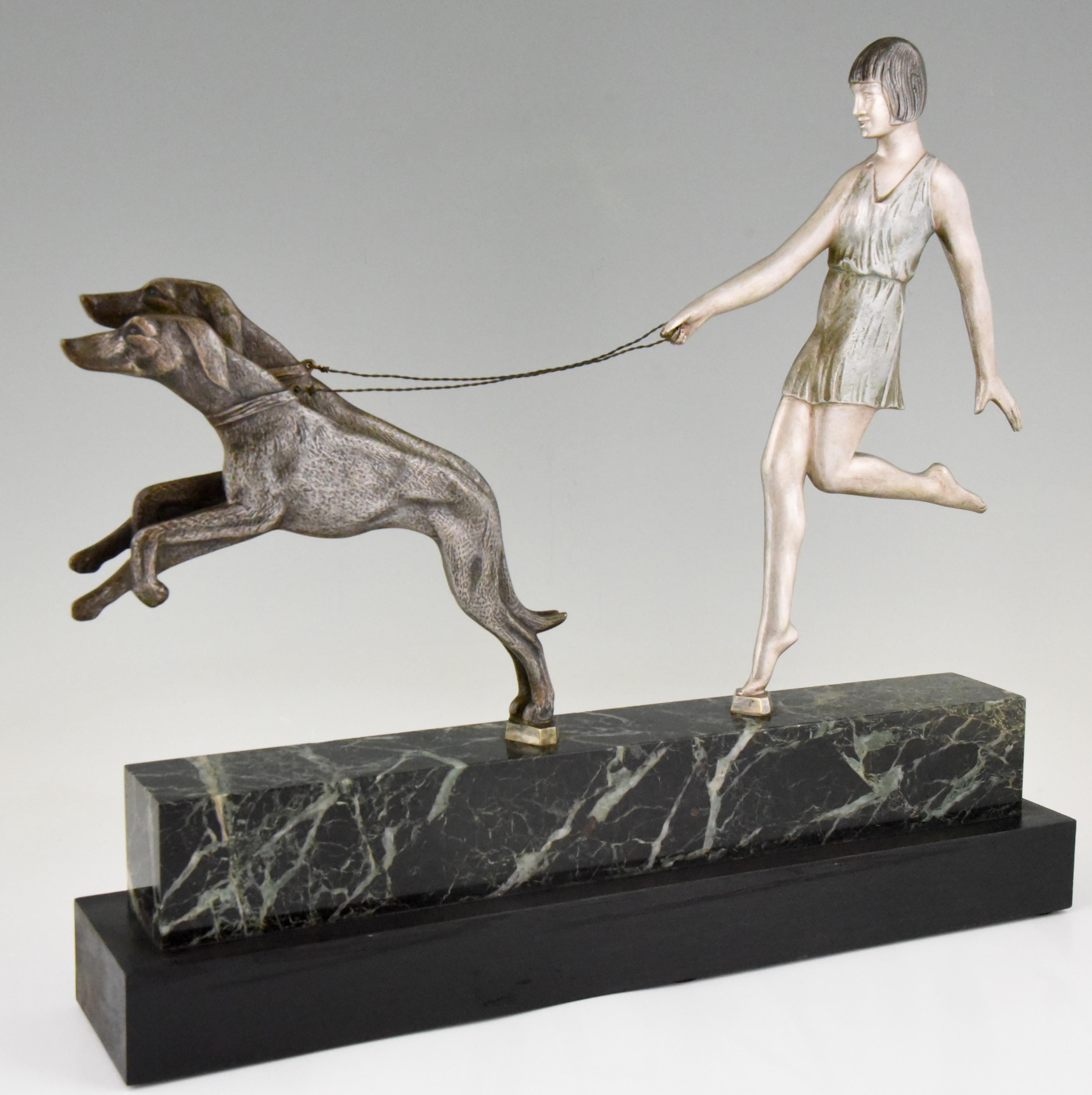 Typical Art Deco sculpture of a young girl with two greyhound dogs on a leash. The bronze sculpture has a beautiful multi color patina and stands on a marble and wooden base. The work is signed by the French artist Janle, circa 1930.