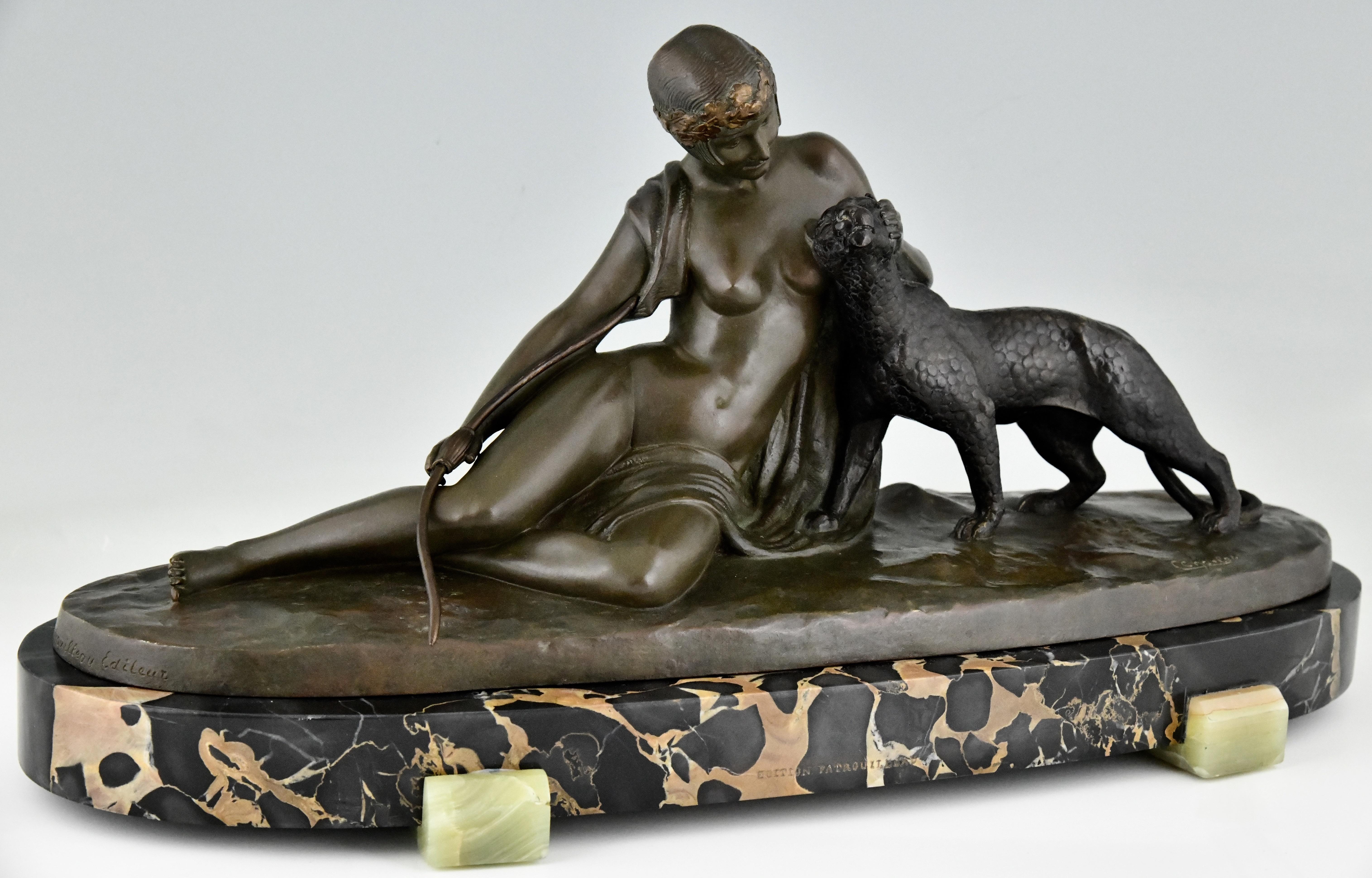 Art Deco bronze sculpture lady with panther signed by C. Charles. The sculpture has the foundry mark of Patrouilleau and is marked Bronze. The lady and panther stand on a Portor marble base with onyx details. France 1930.

The dictionary of