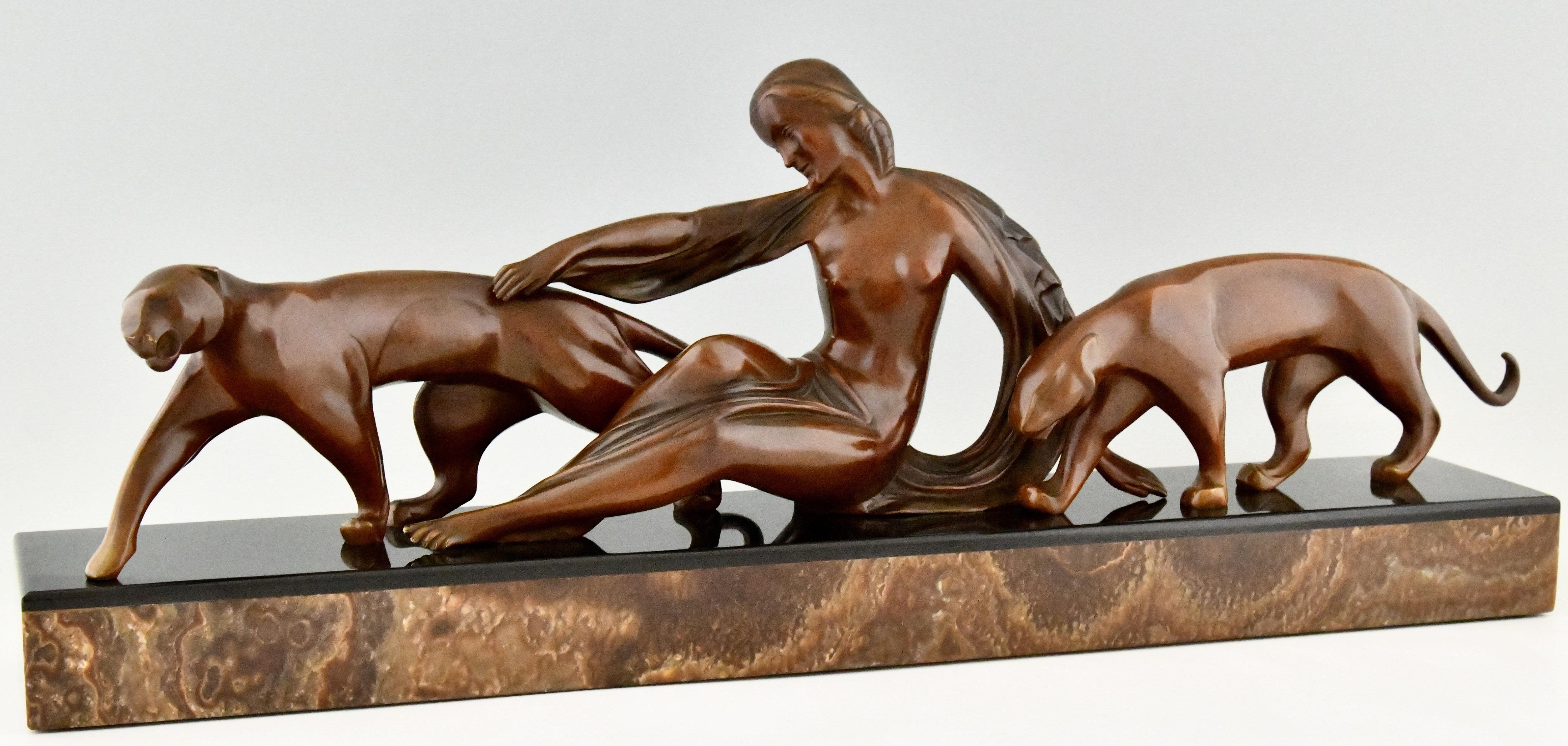 Impressive Art Deco bronze sculpture of a lady with two panthers by Michel Decoux, 1837-1924. Patinated bronze on a black and brown marble plinth. France 1920. 
A similar model is illustrated on page 294 of the book Dictionnaire illustré des