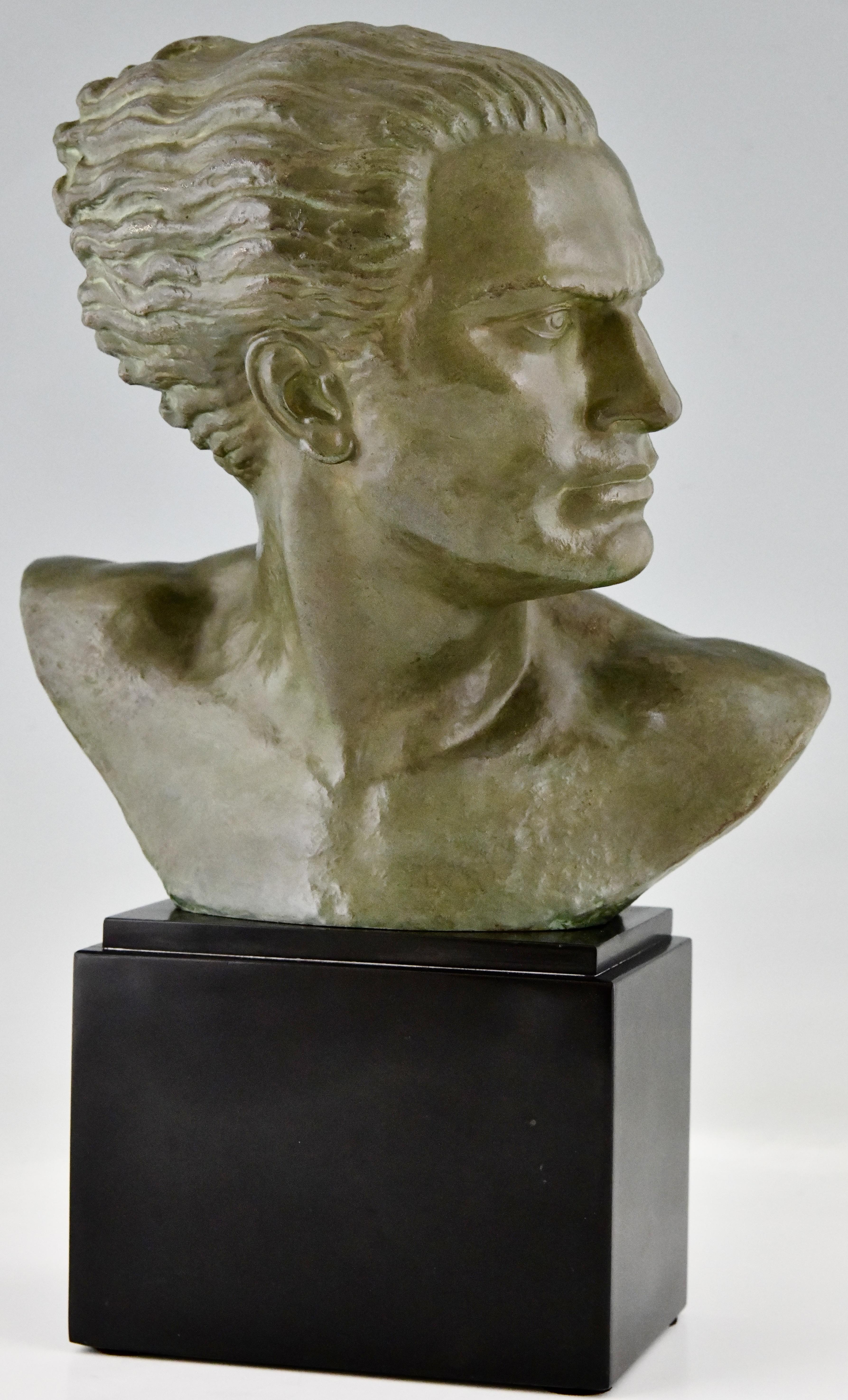 Art Deco bronze sculpture male bust of the aviator Jean Mermoz by Alfred Gilbert 1854-1934. The sculpture has a lovely green patina and stands on a belgian black marble base. France 1925.
This bronze is illustrated in Bronzes, sculptors and