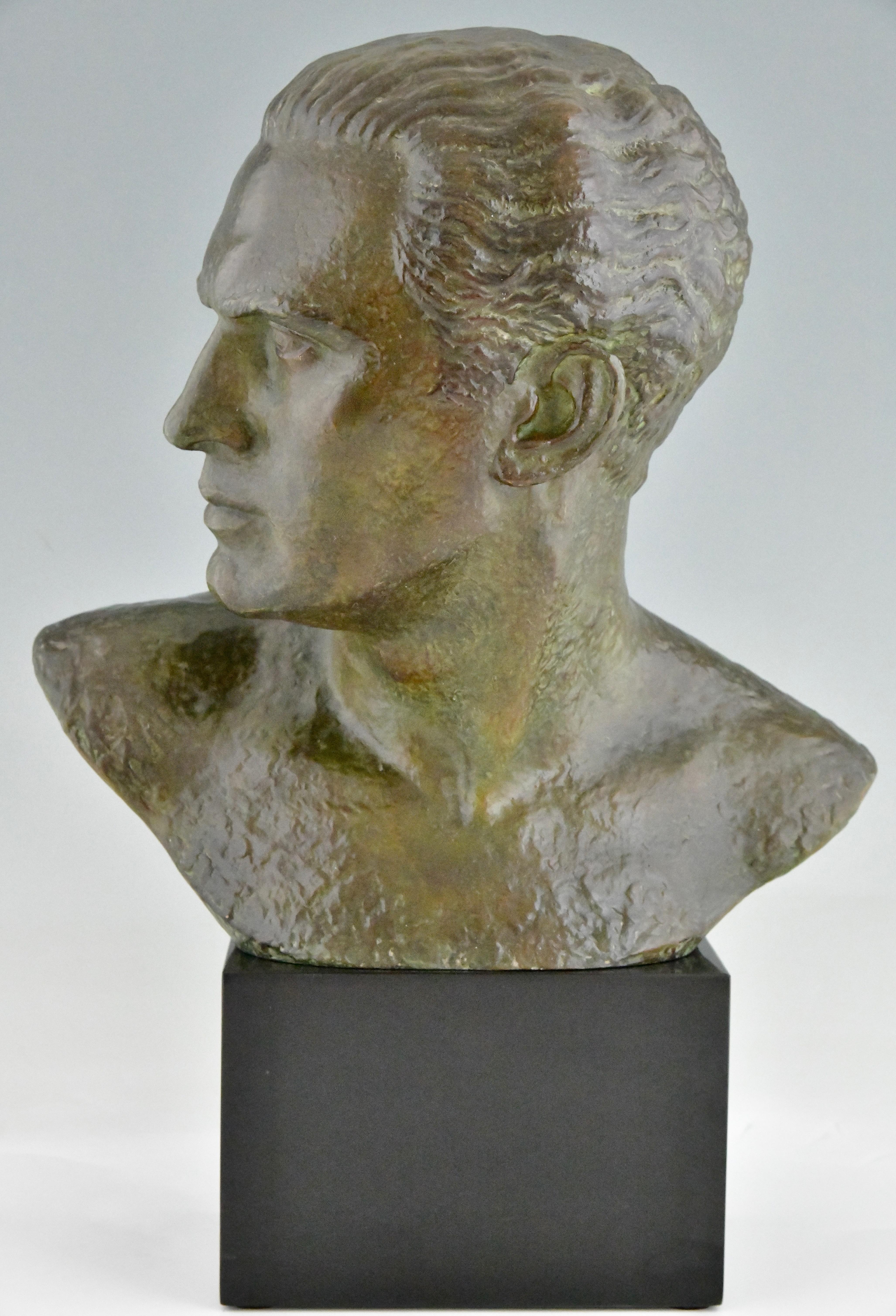 Art Deco bronze sculpture male bust aviator Jean Mermoz by Lucien Gibert. 
The sculpture has a lovely green patina and stands on a Belgian Black marble base.
Impressive size. France 1925.
A similar model is illustrated in  
Bronzes, sculptors and