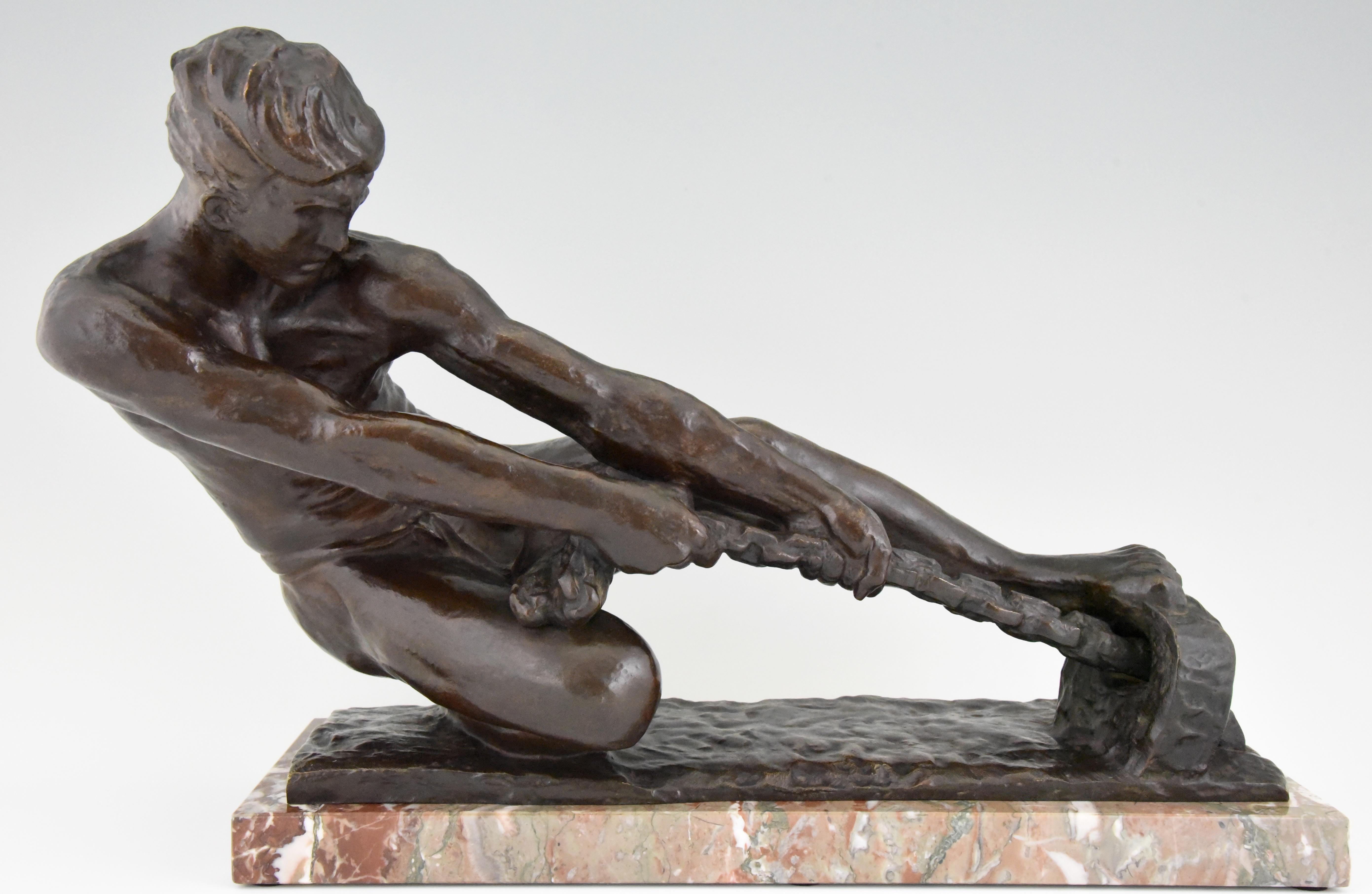 Art Deco bronze sculpture of a athletic young man pulling a rope by the French artist Alexandre Kelety. The bronze has a lovely dark brown patina and is mounted on a marble base. The sculpture is signed Kelety and has the Etling foundry mark,