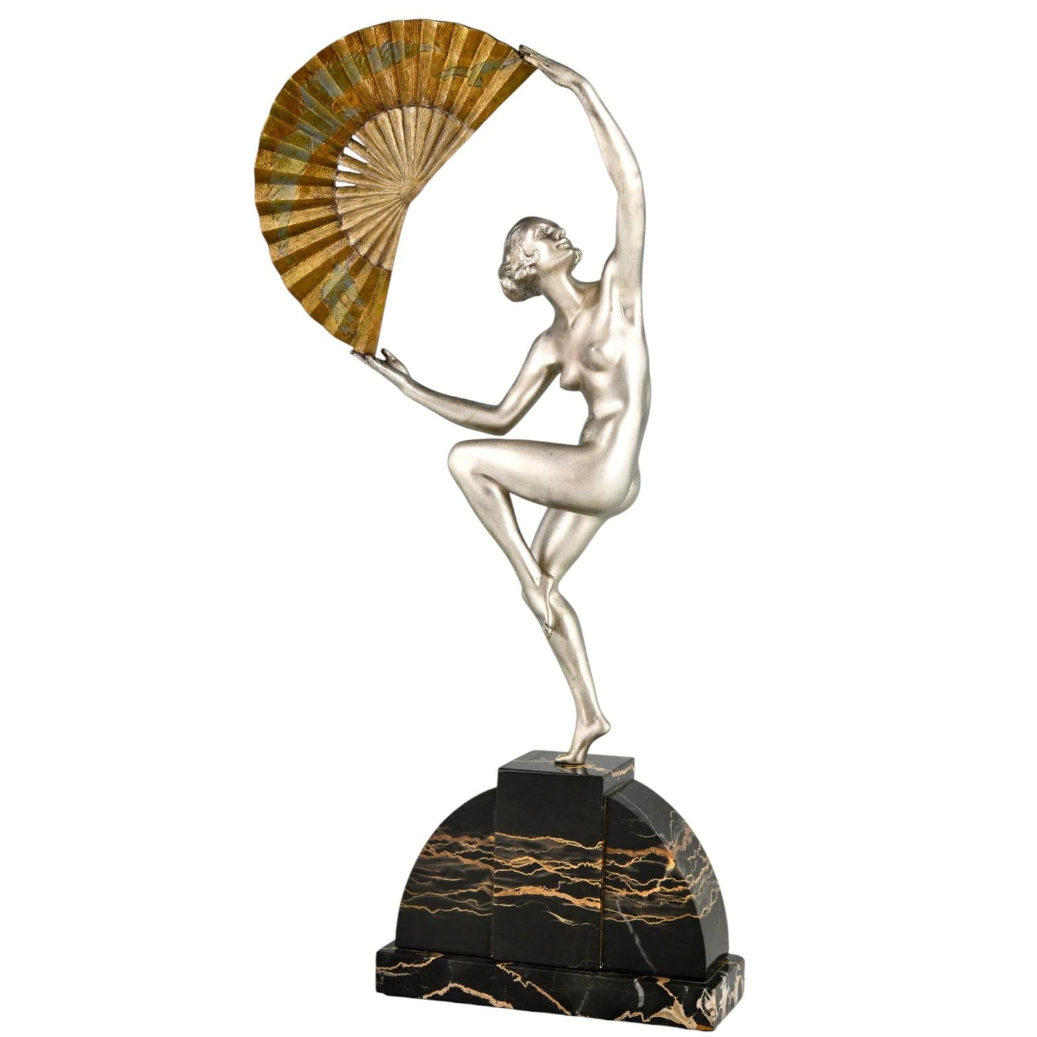 Art Deco bronze sculpture nude fan dancer by Marcel André Bouraine with Etling Paris Founders' signature on a Portor marble base.
Sculpture in silvered and patinated bronze of a dancing nude standing on one foot holding a fan incised with a design