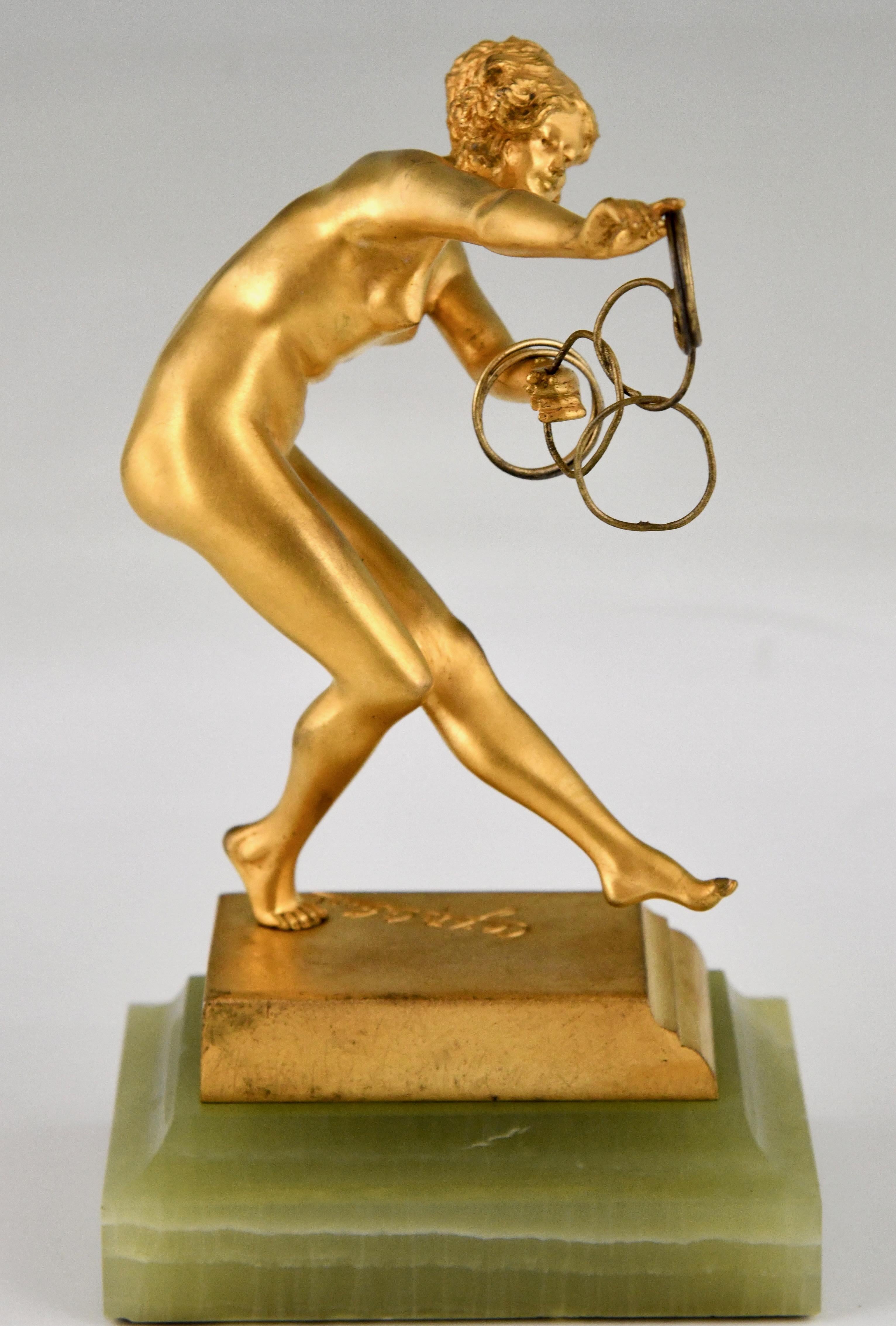 Art Deco bronze sculpture nude ring dancer by Claire Jeanne Roberte Colinet. 
Entitled The magic links.
Signed Cl. J. R. Colinet, with Foundry mark SPA. Numbered. 
Gilt bronze on onyx base. 
France 1925. 
This model is illustrated in:
Art Deco and
