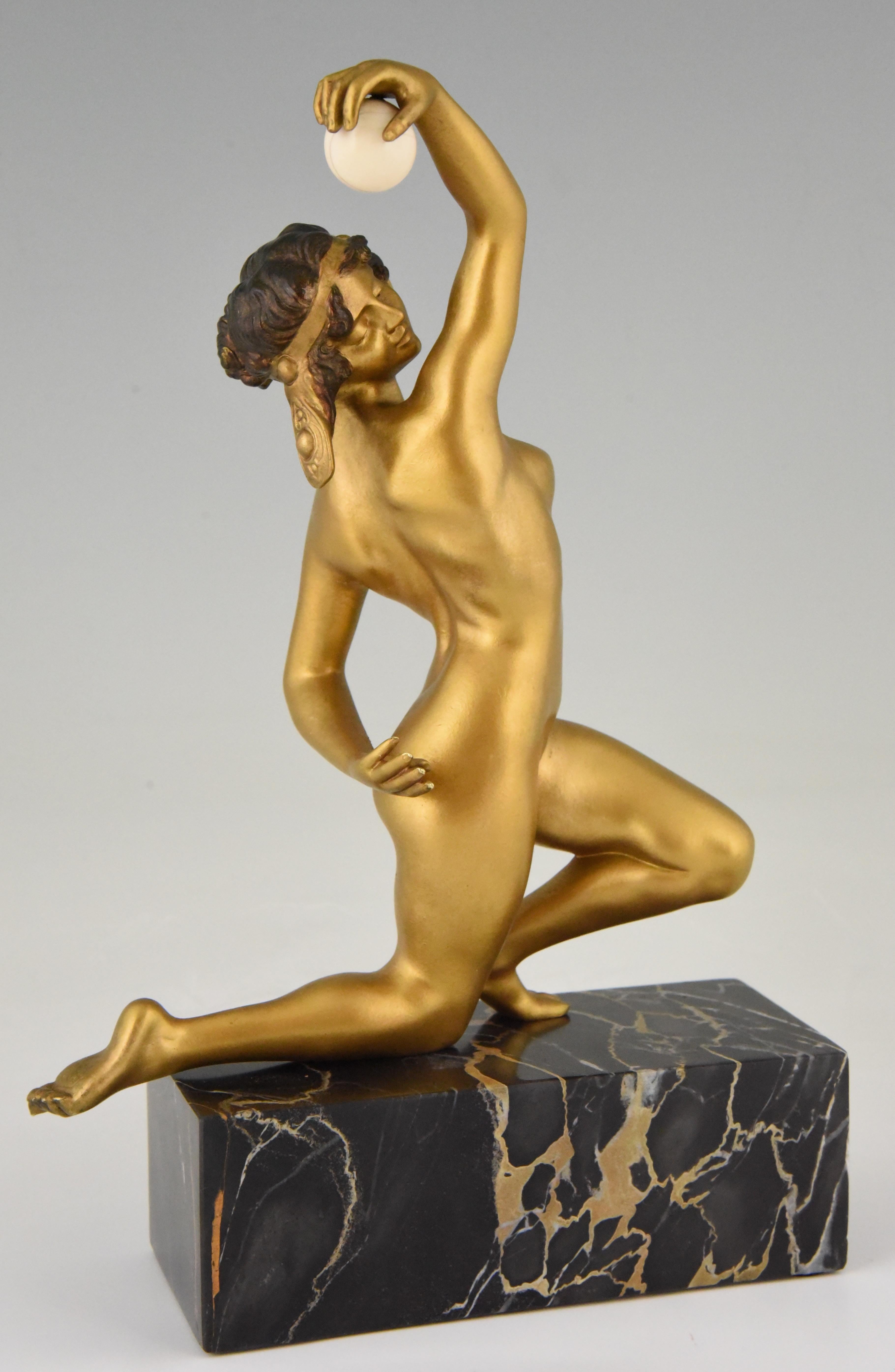 Art Deco bronze sculpture of a kneeling nude juggling with a ball. The bronze has a golden patina and is signed by the French/Italian artist Affortunato Gory. 
This bronze is illustrated on page 1152 of ? “Bronzes, sculptors and founders” by H.