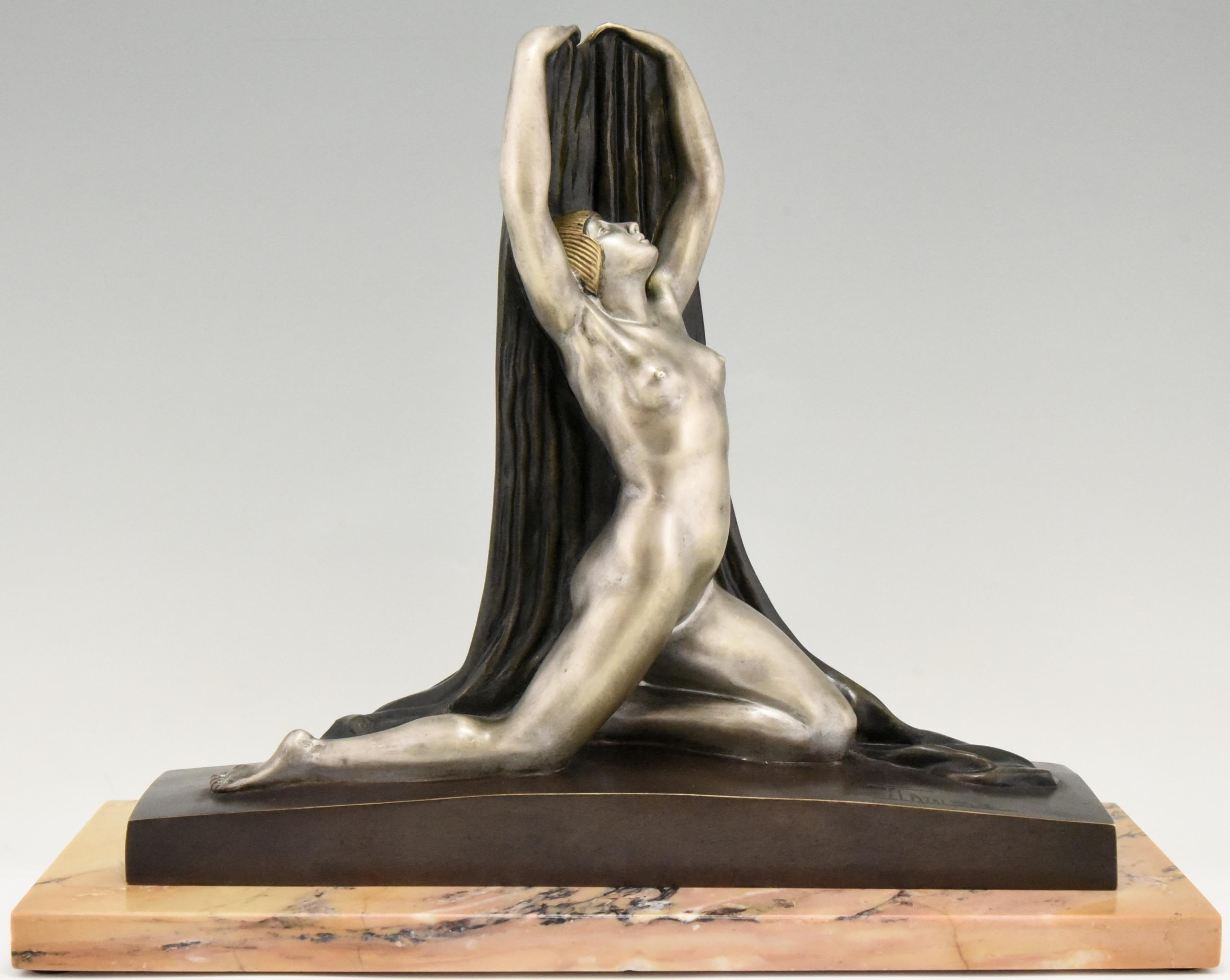 Art Deco bronze sculpture of a nude in split pose with arm outstretched holding a scarf behind her on a marble base. Beautiful multi-color patina. Signed in the bronze F. Trinque, circa 1920.
Elton John had the same bronze in his