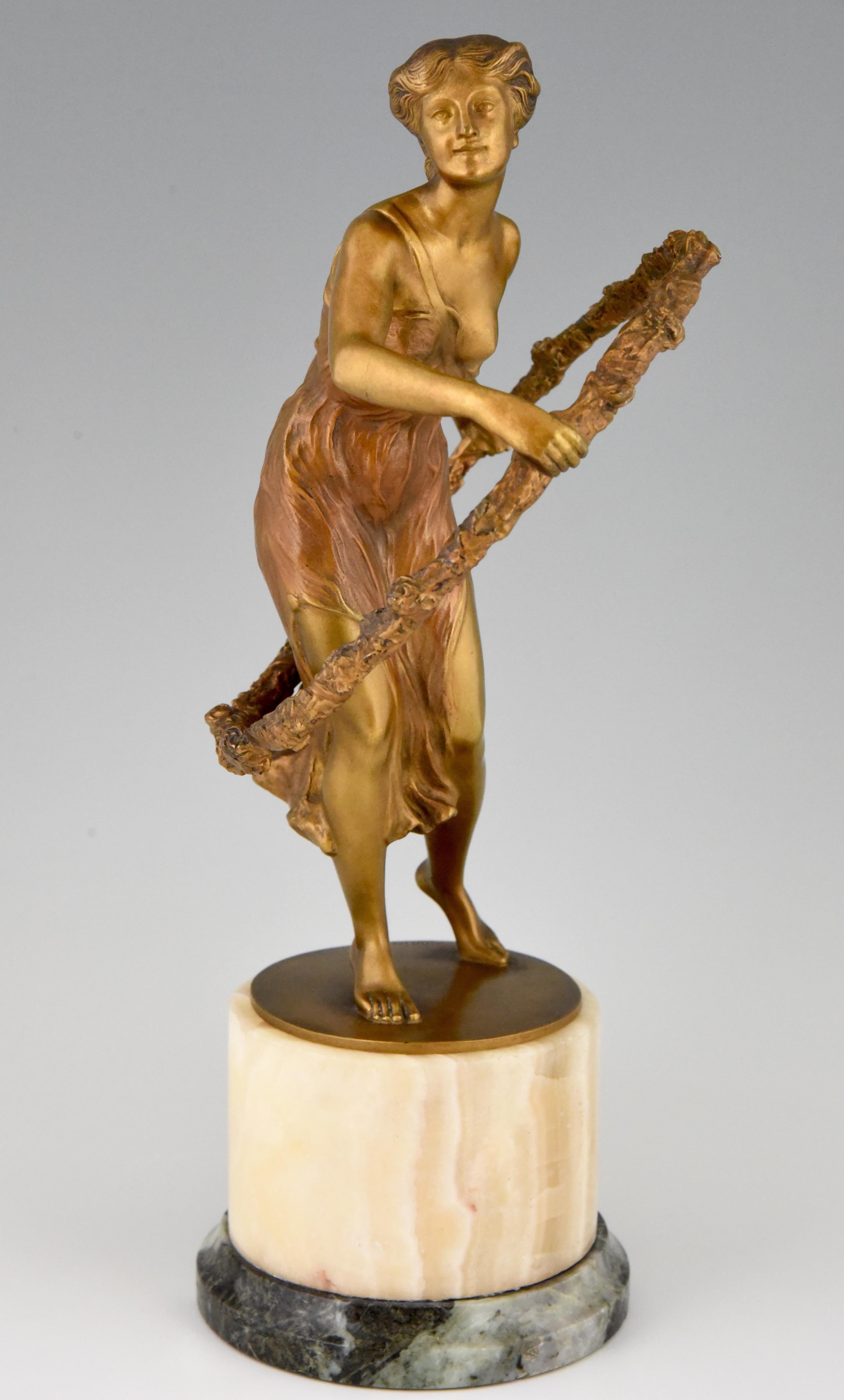 Art Deco sculpture of a hoop dancer by Georges Morin. The girl is wearing a flowing dress and the hoop is decorated with flowers. The fine quality gilded and patinated bronze stands on a circular marble base. Cast in France, circa 1920.