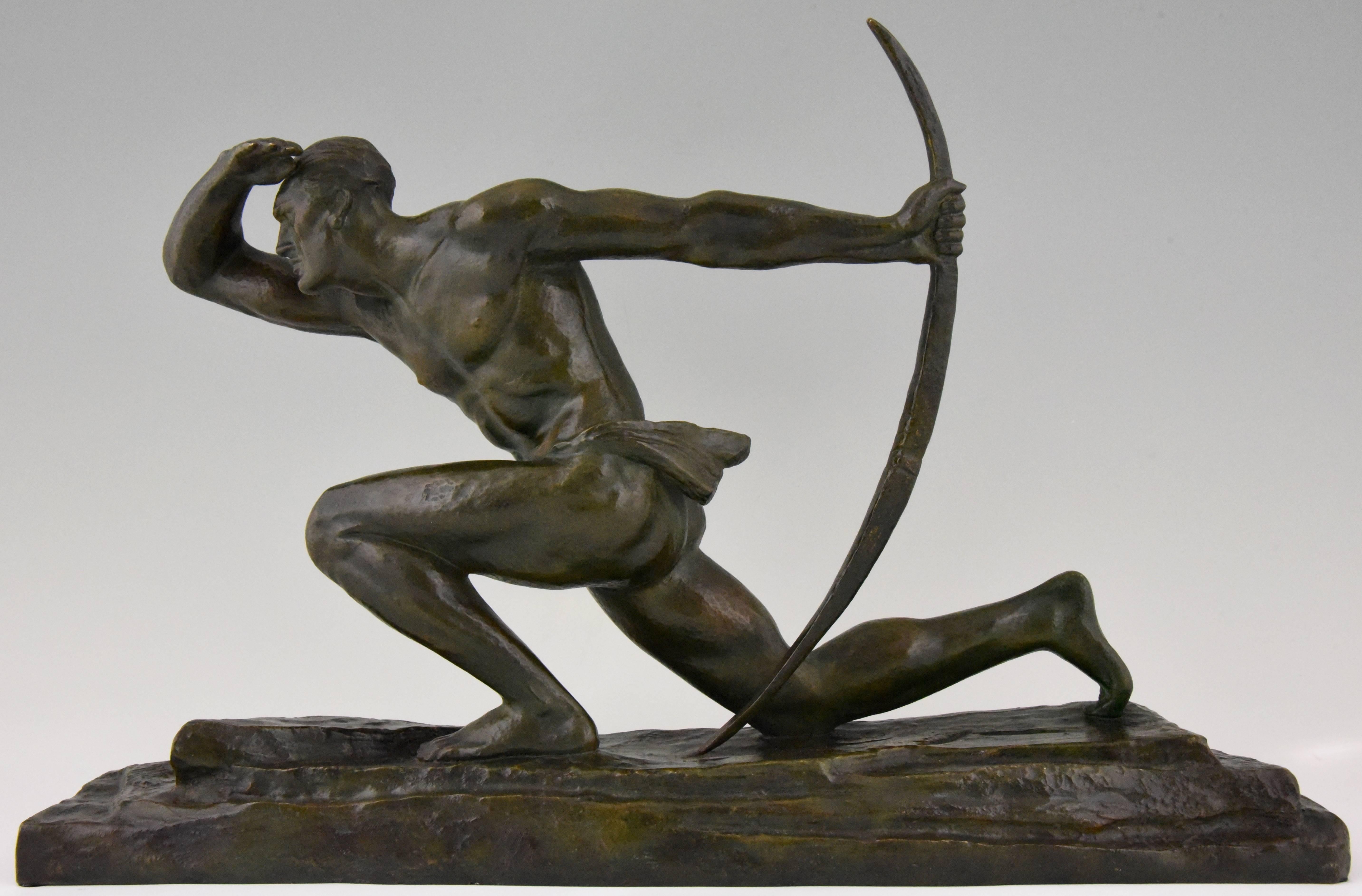 The Archer, a bronze sculpture of a kneeling man holding a bow by the French artist Pierre Le Faguays with a nice green patina.