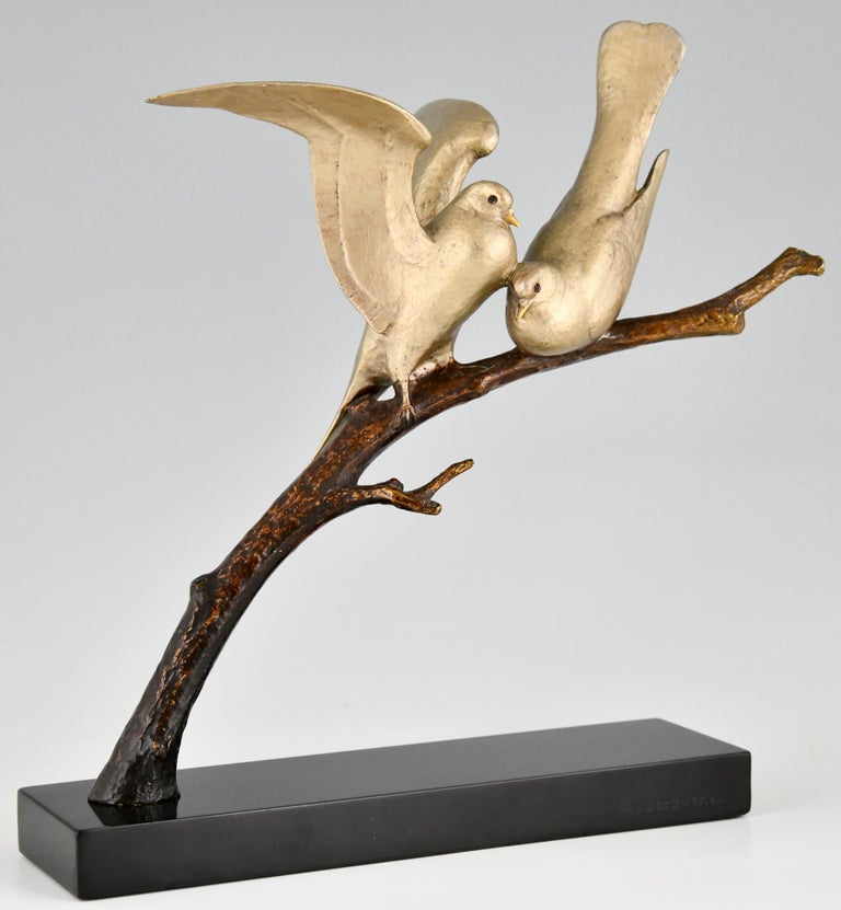 Bronze Art Deco sculpture of two lovebirds sitting on a branch by the French sculptor Andre Vincent Becquerel. The bronze has a silver and brown patina and is mounted on a Belgian Black marble base. France ca. 1930. 

This model is illustrated in