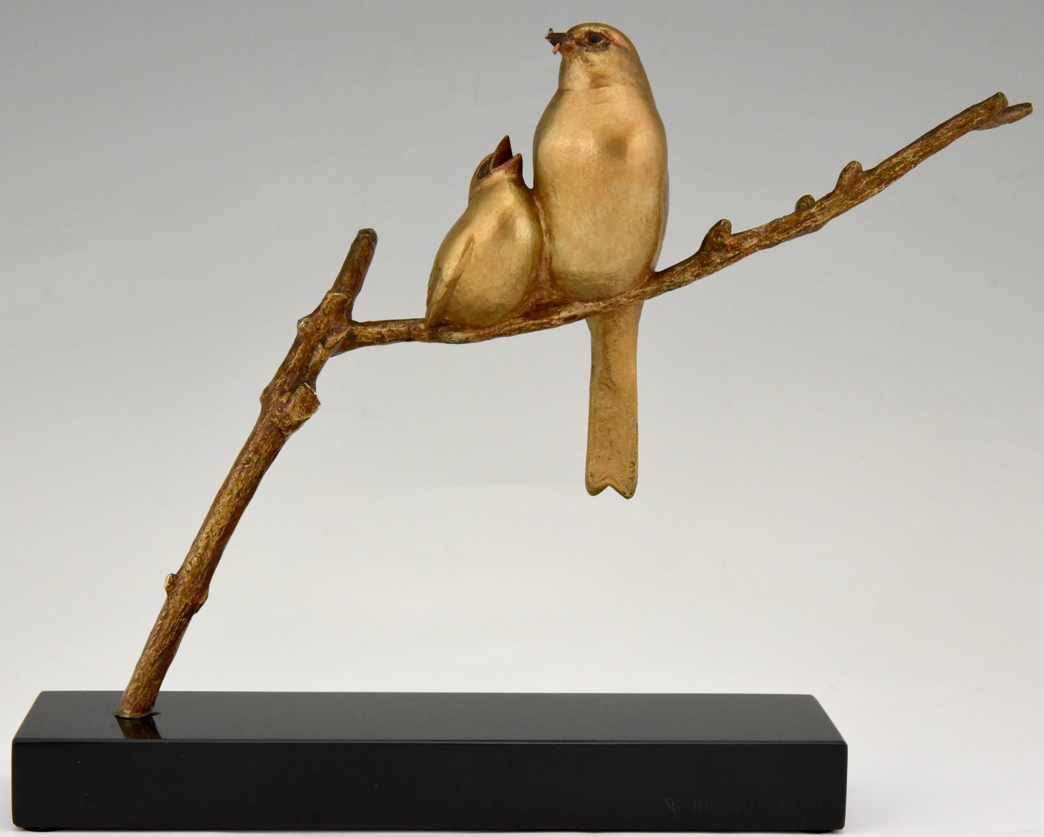 Art Deco bronze sculpture of a mother bird feeding her chick.
Both birds are sitting on a branch. The bronze has a golden patina and stands on a Belgian Black marble plinth. Signed by the famous artist Andre Vincent Becquerel, France,