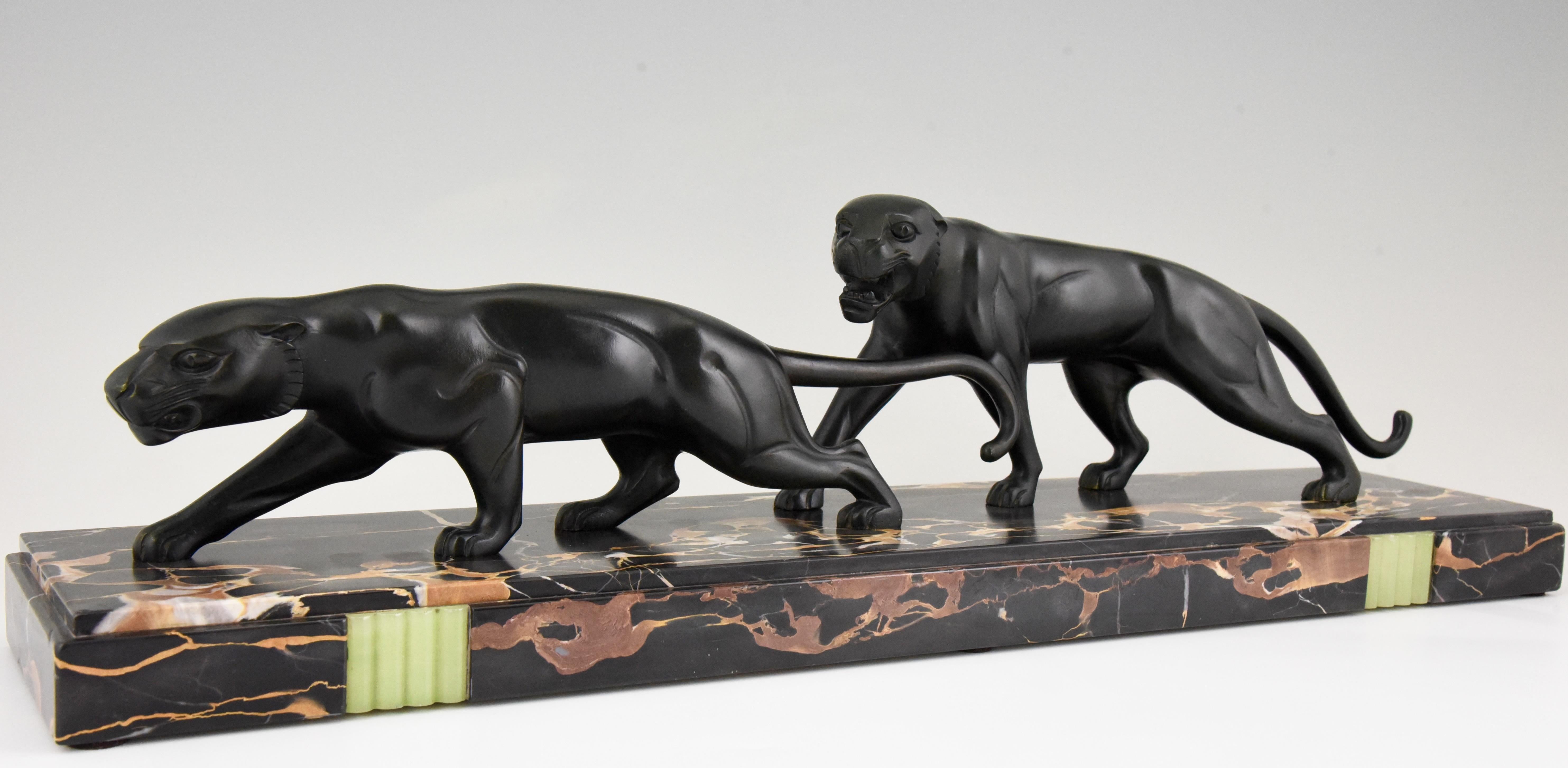 Beautiful bronze Art Deco group of two panthers by the French artist Dominique Jean Baptiste Hugues. The sculpture has a lovely patina and stands on a Portor marble base with onyx inlay. France 1930.
Literature:
“Dictionnaire des peintres,