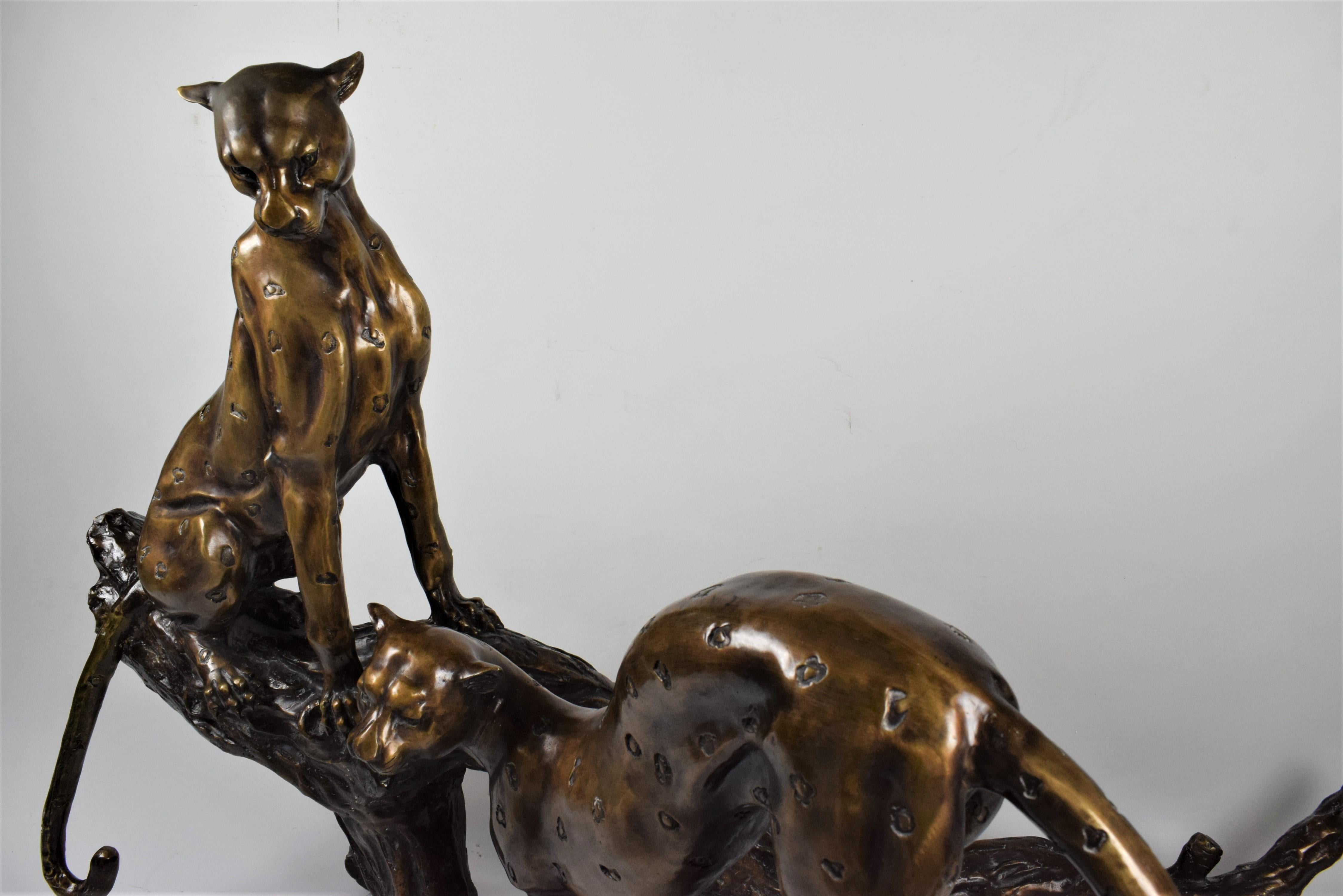 Cast Art Deco Bronze Sculpture of Two Resting Cheetah's on a Trunk For Sale
