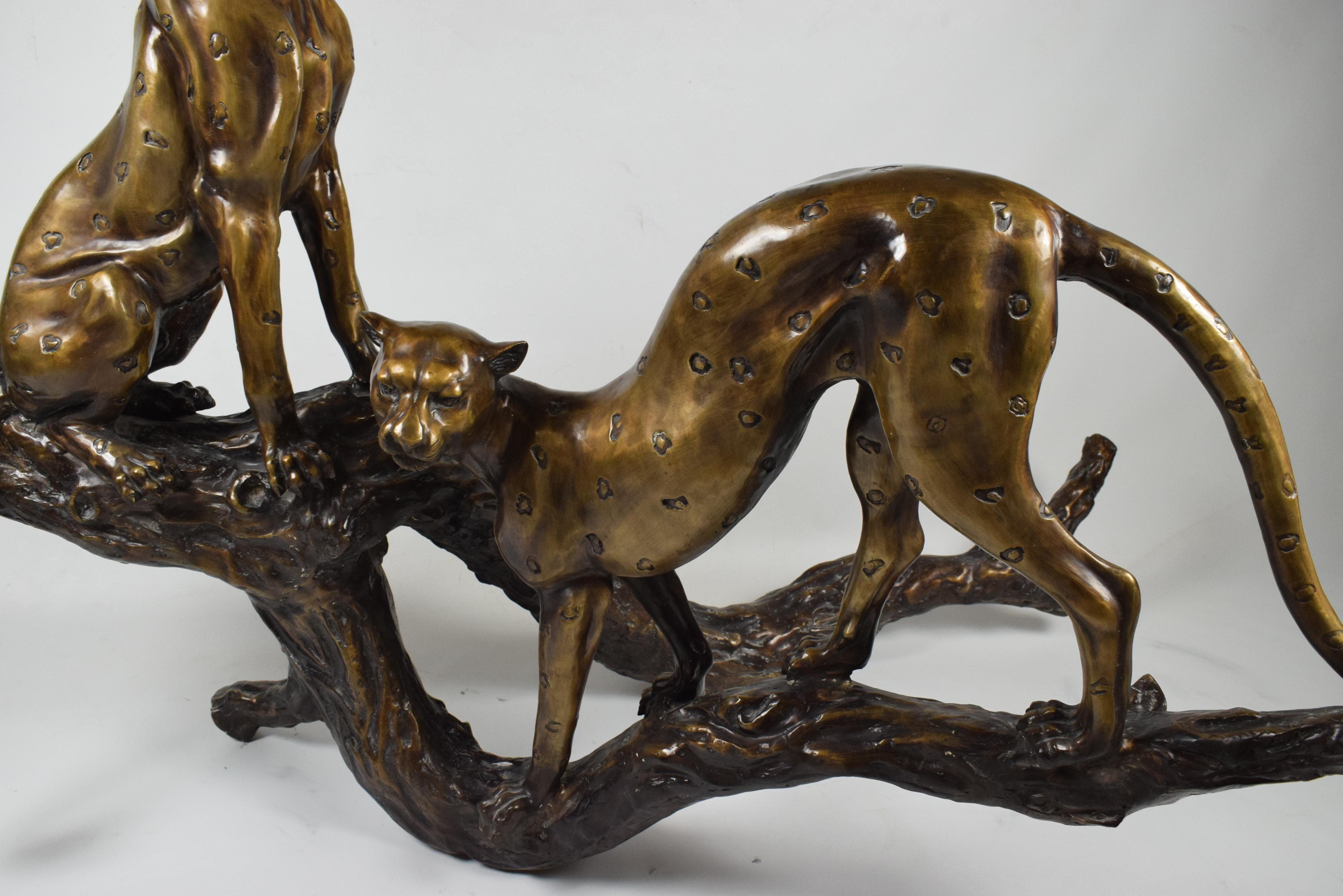 Calco Scultura in bronzo Art Deco di due ghepardi che riposano su un tronco in vendita